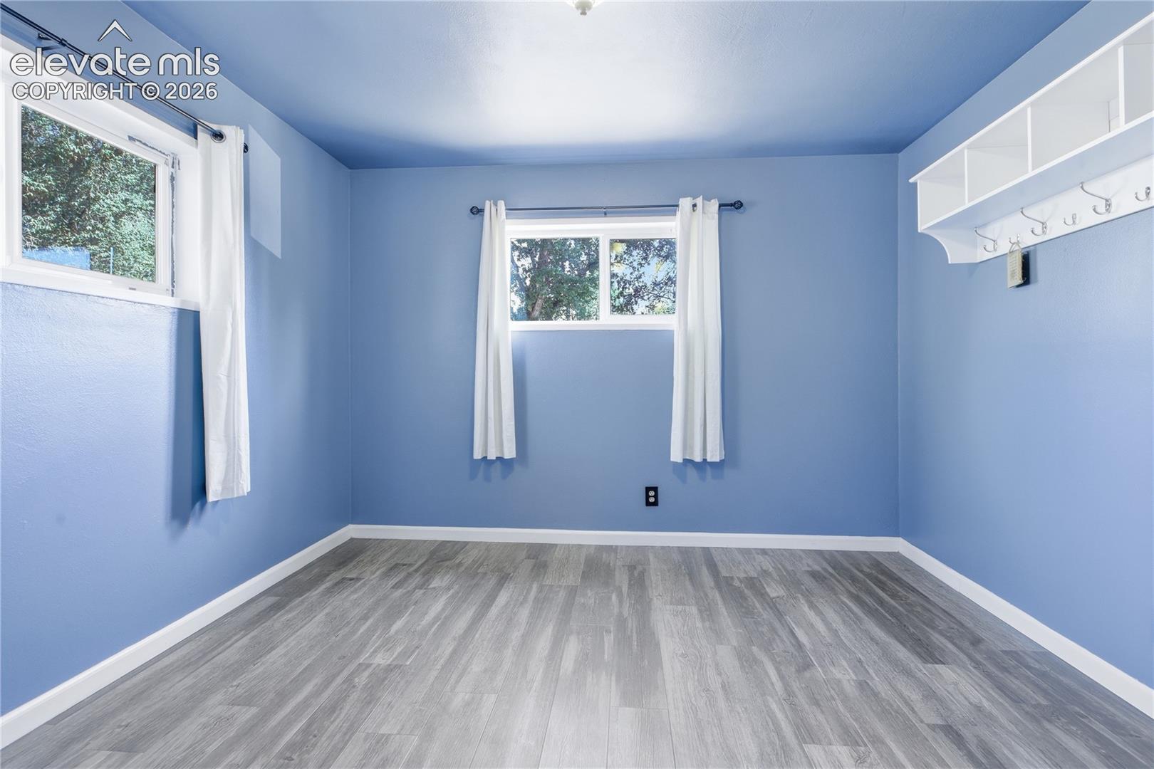 LAUNDRY AREA OFFERS ADDITIONAL CABINET STORAGE AND WALK-OUT TO BACKYARD