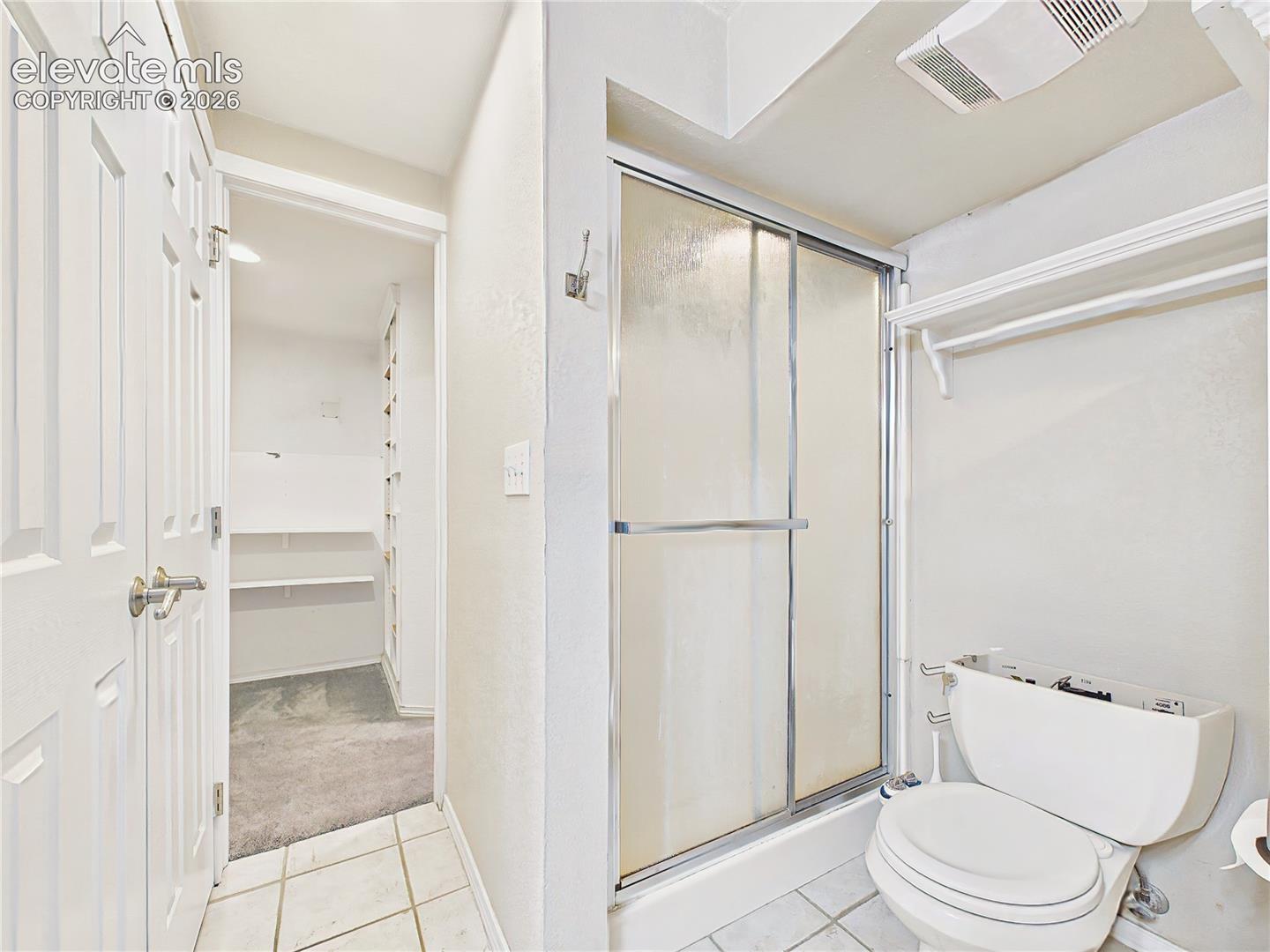 Primary bath featuring a separate shower, private water closet, and convenient access to the adjoining walk-in closet. Lower Level