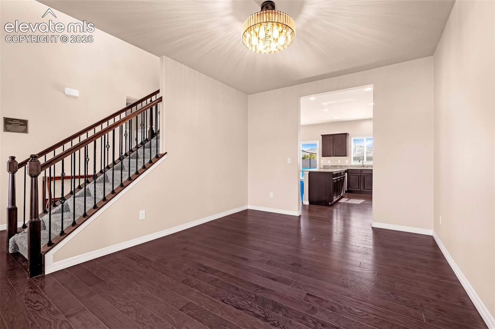 Dark wood-finish flooring with light-toned walls