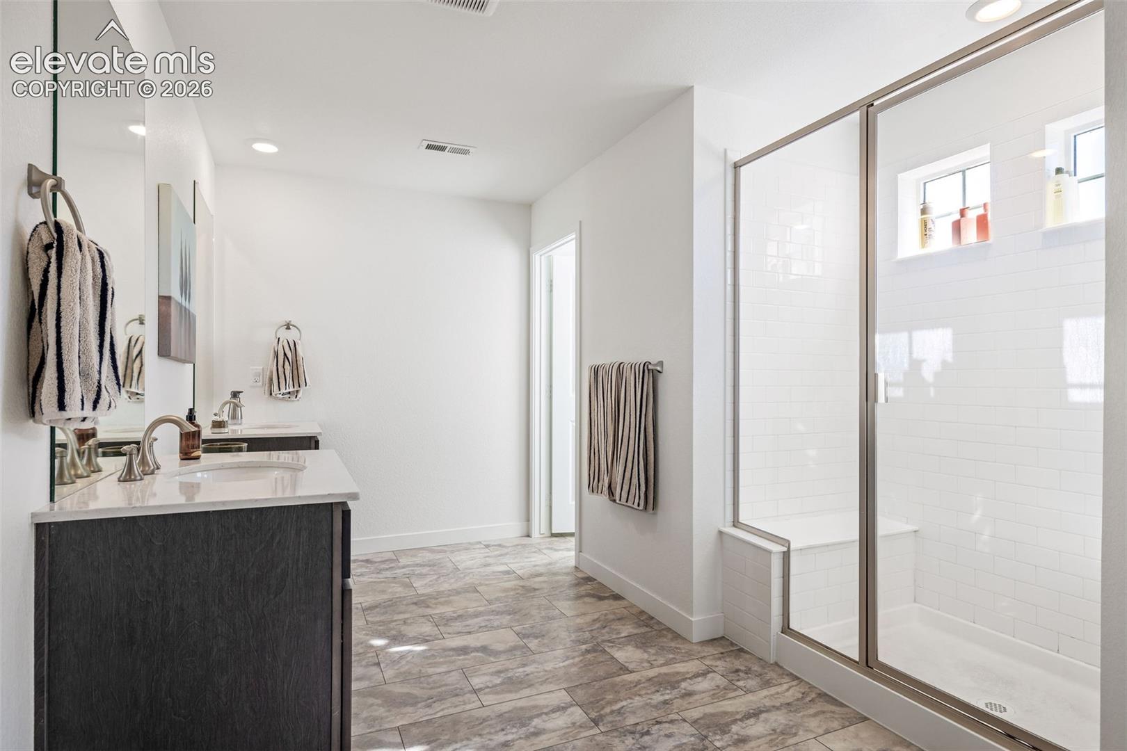 Dual vanity with undermount sinks and light-toned countertops