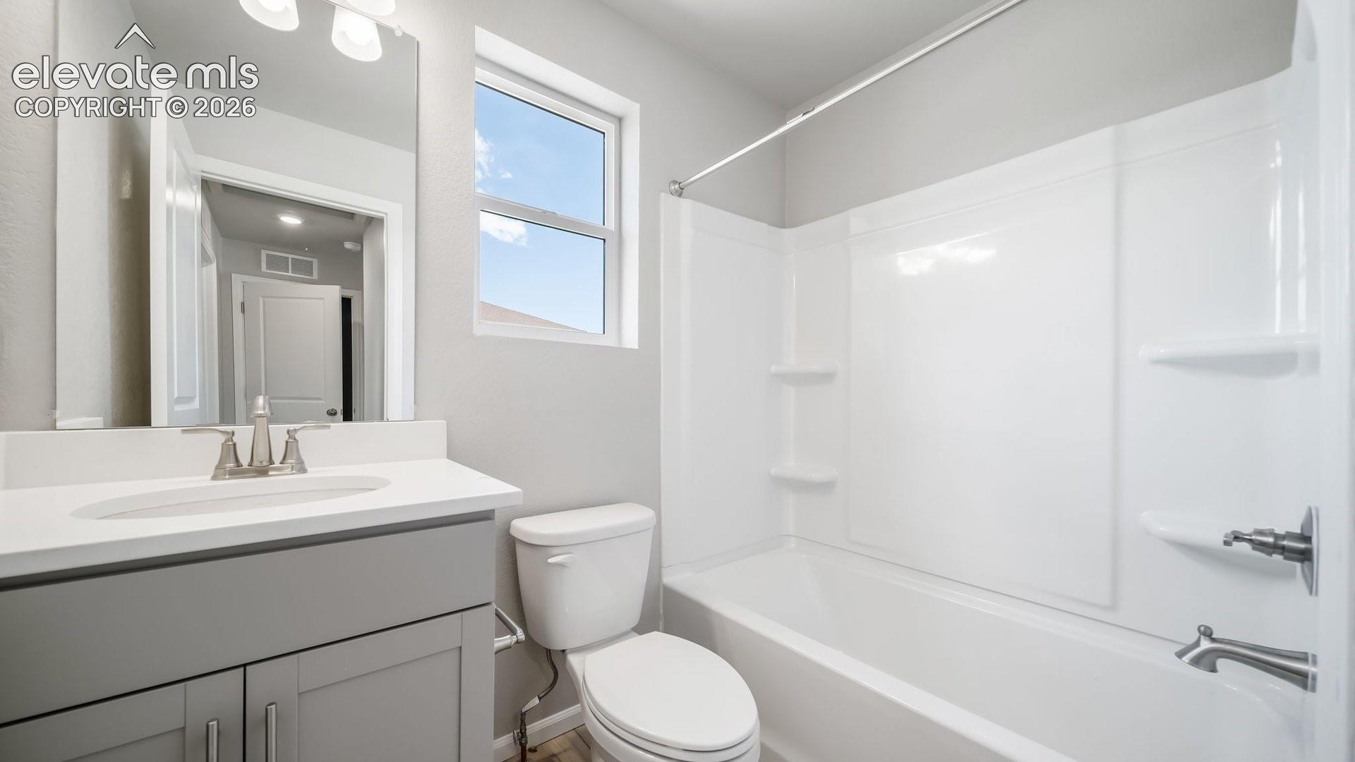 Bathroom featuring a vanity with a light-toned countertop, integrated basin, and brushed nickel faucet
*photos of a model home*