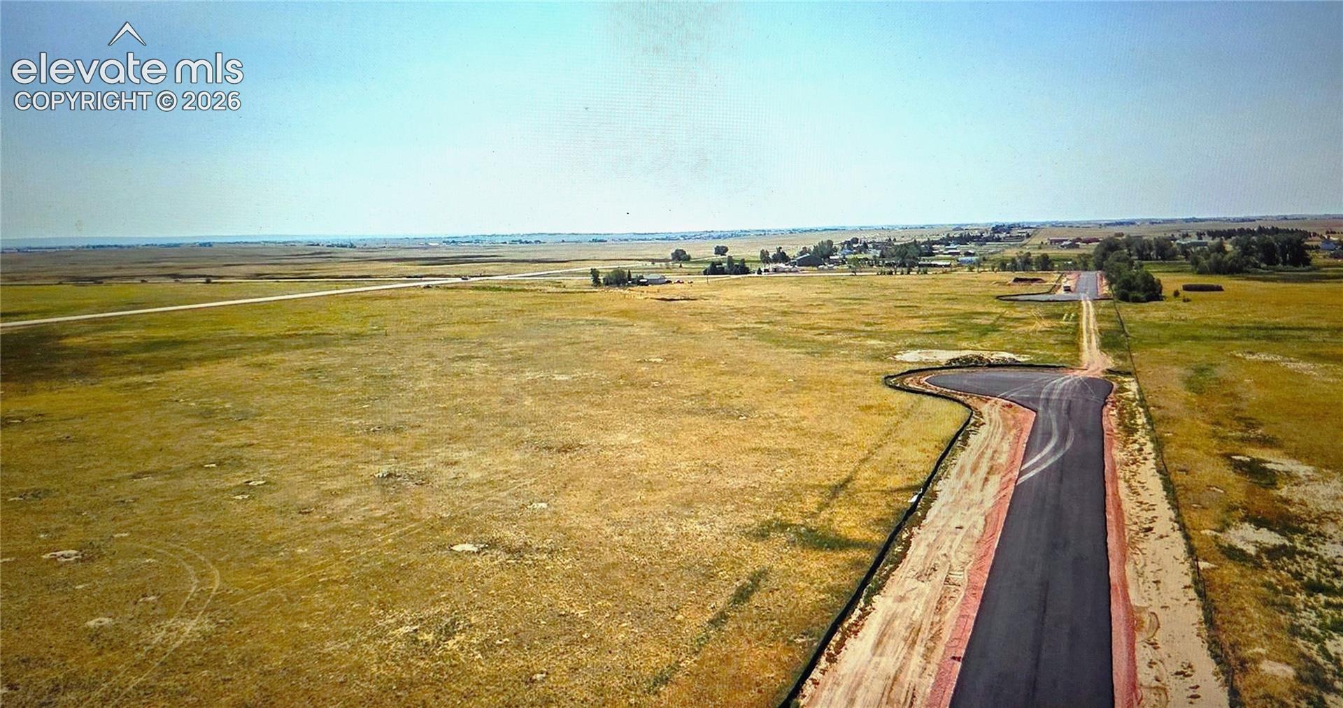 Expansive undeveloped land featuring a paved cul-de-sac and direct road access