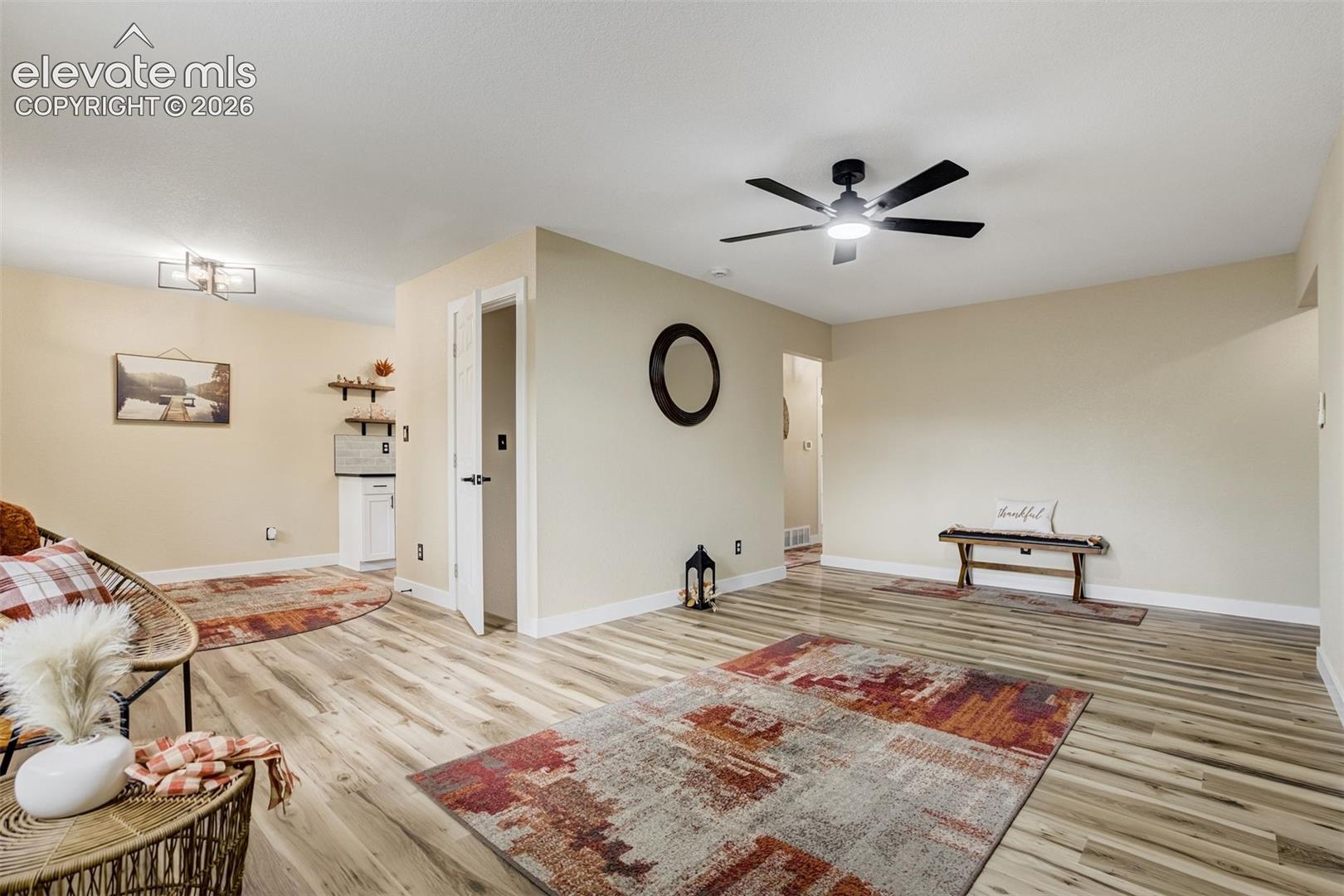 Living room connects to the dining room and kitchen. Door leads to the full finished basement. 