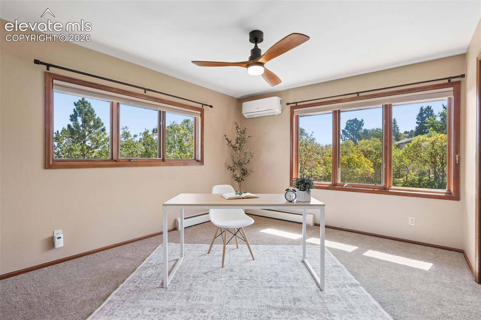 Dual pane windows, wood window frames, ceiling fan, split unit air conditioning, and carpeted flooring