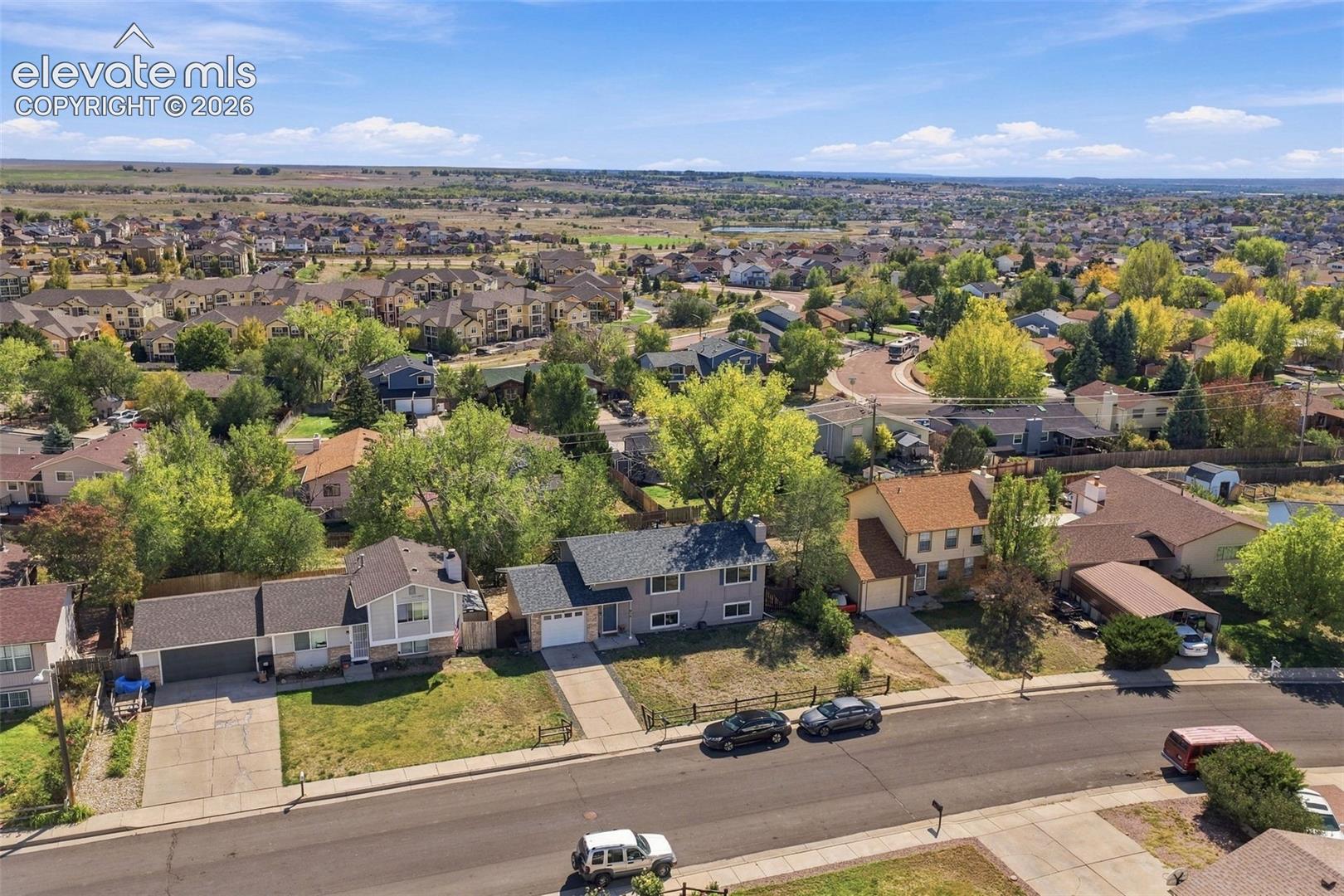 Residential neighborhood with mature trees, paved streets, and a variety of architectural styles