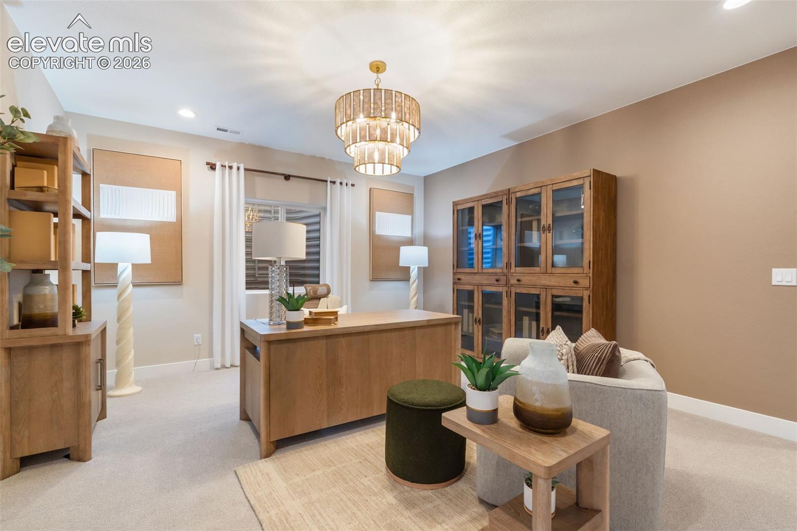 Multi-tiered tiered drum chandelier, built-in wooden cabinetry with glass-paneled doors, neutral wall palette, and recessed ceiling lighting