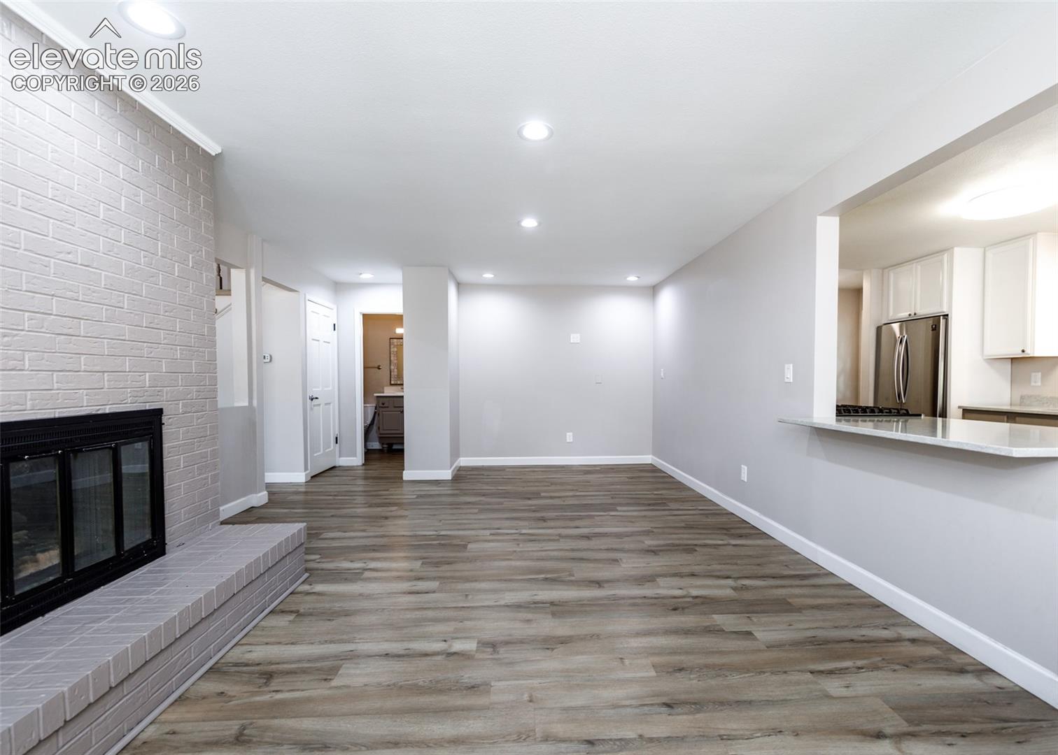 Wood-finish flooring throughout, complemented by recessed lighting