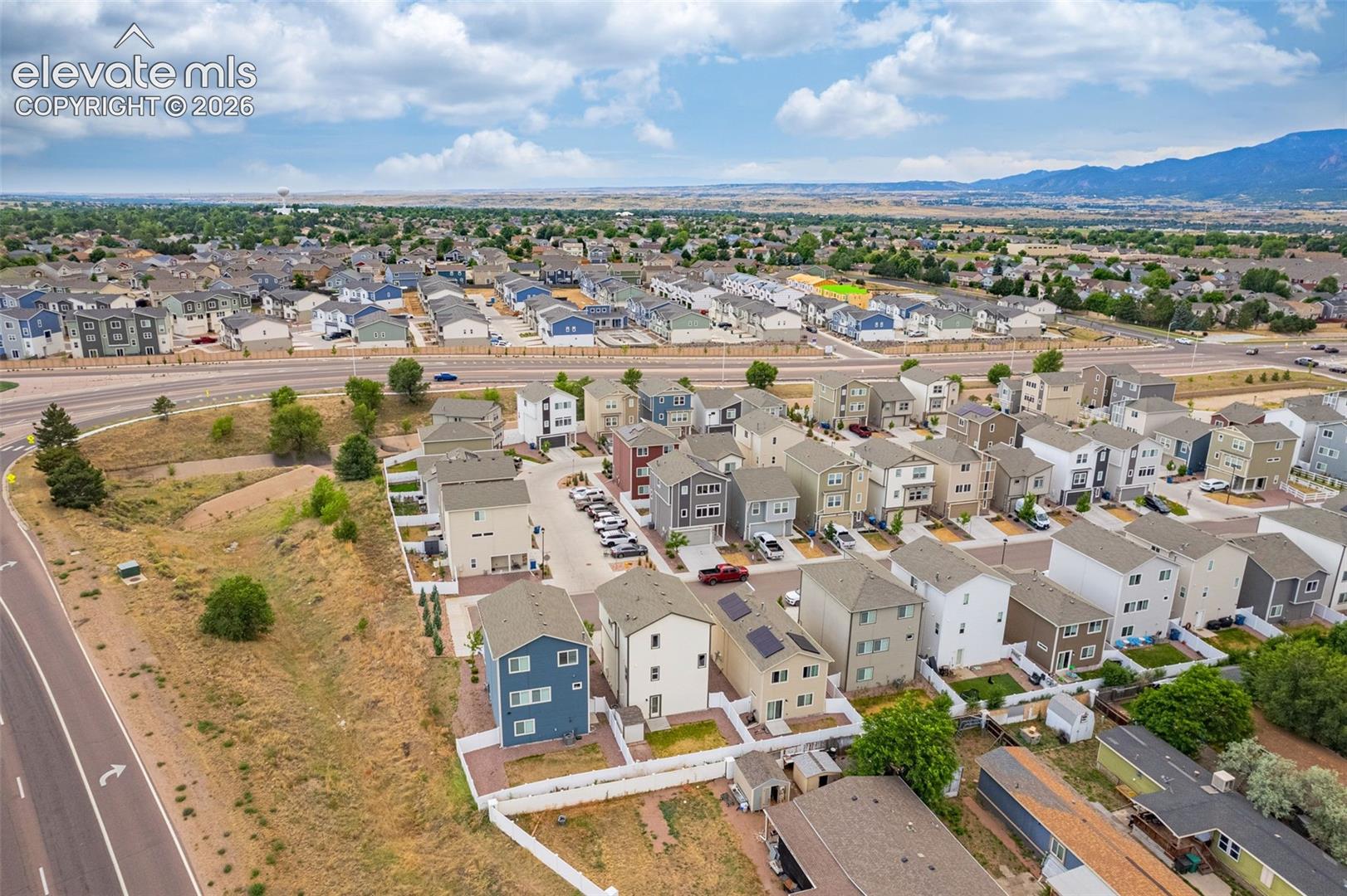 Aerial perspective showcasing a residential development with multiple detached homes