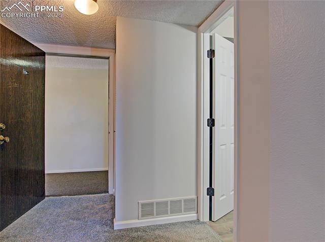 Upstairs hallway with furnace closet and secondary access