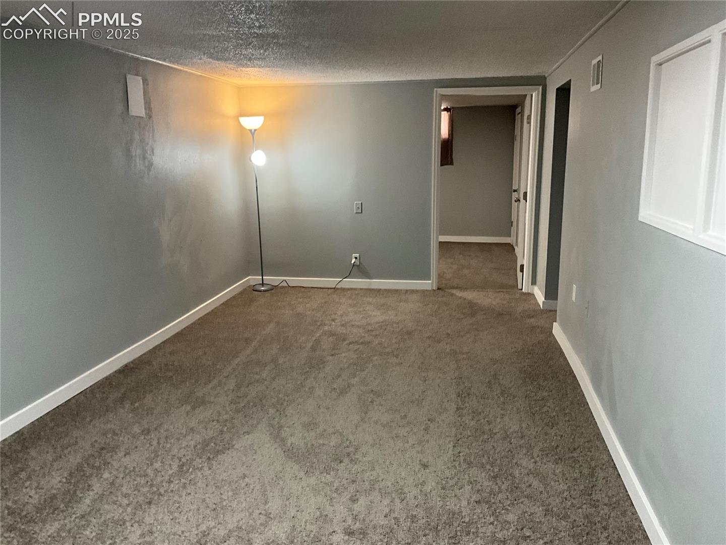 Spare room with new carpet floors and a textured ceiling
