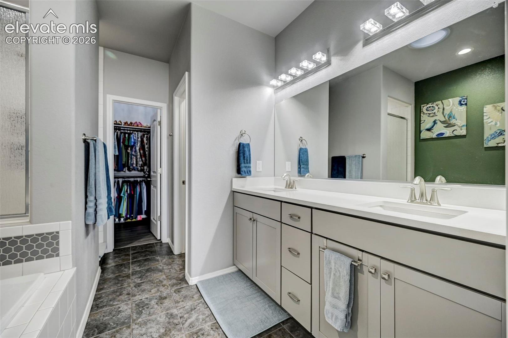 Dual vanity with light gray cabinetry, brushed nickel hardware, and white countertops