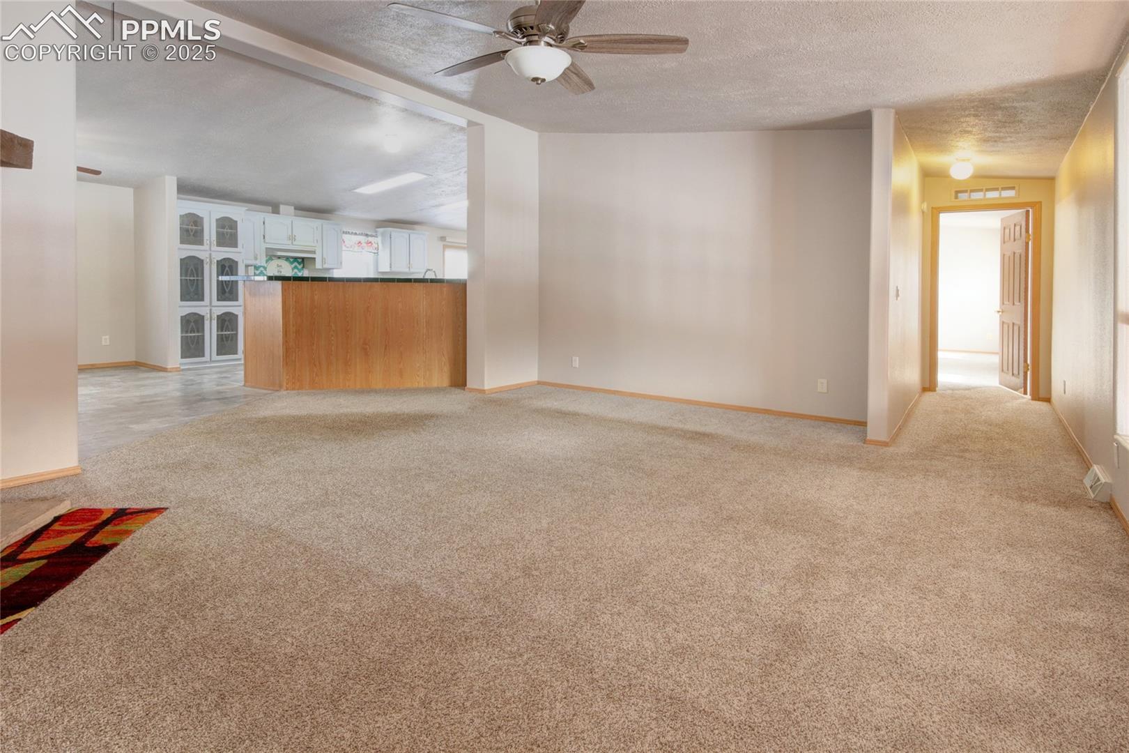 Living room has a ceiling fan