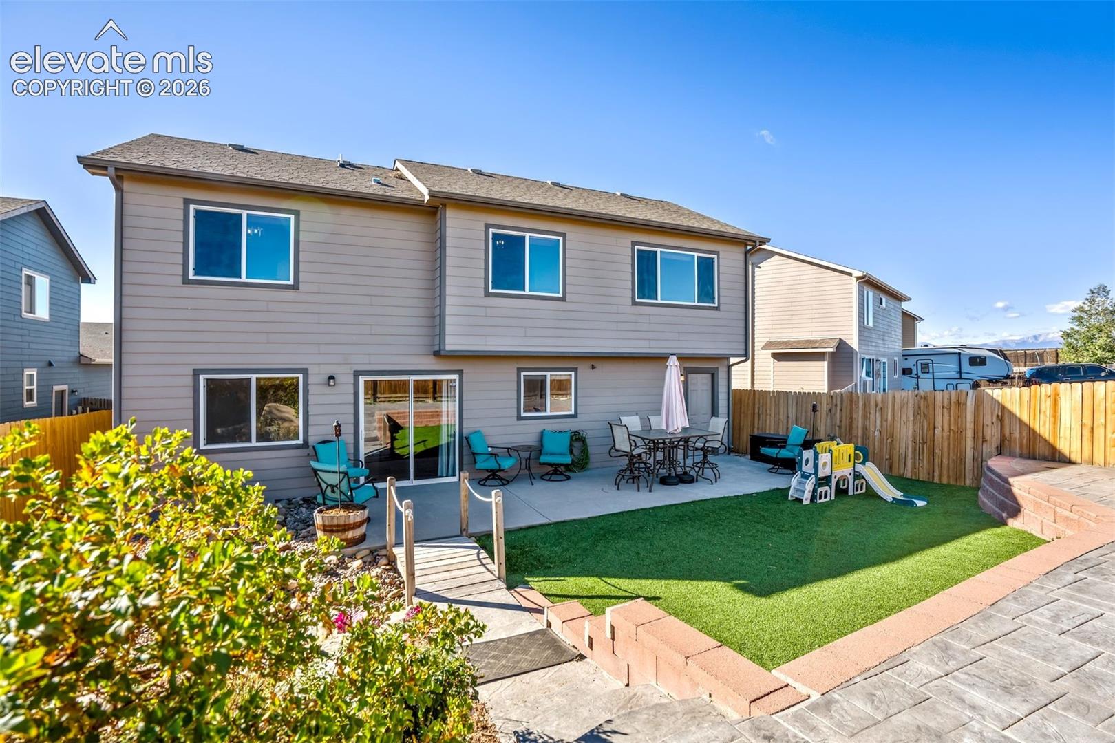 Lovely backyard space with turf, concrete patio space, and privacy. 