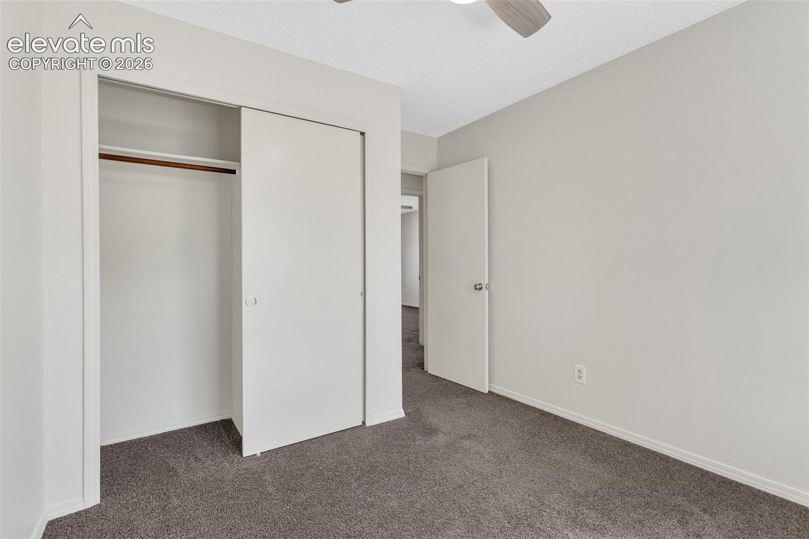 3rd bedroom w/wall-to-wall carpeting, and a ceiling fan