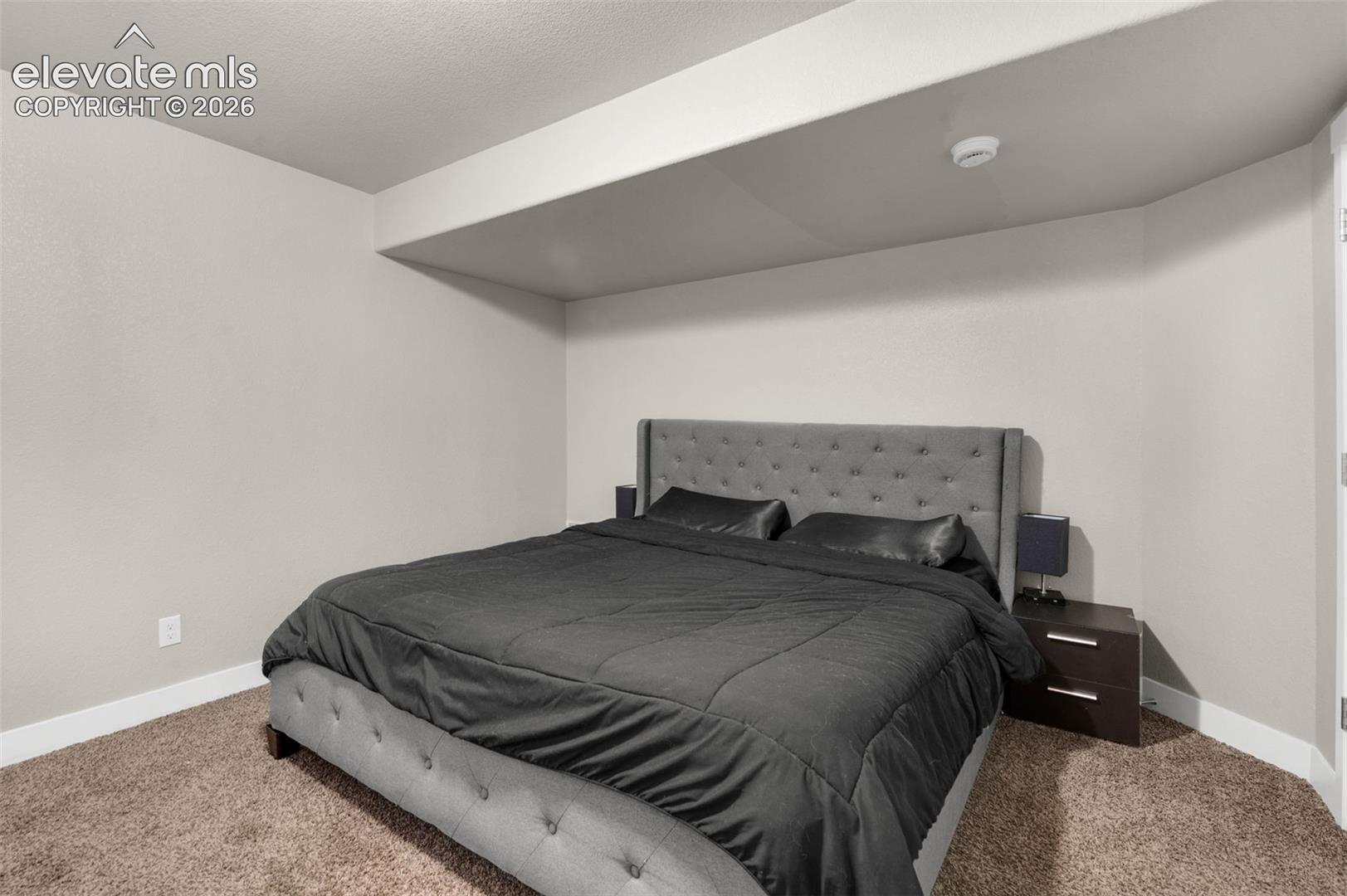 Neutral wall color, soft carpeting, and recessed ceiling detail