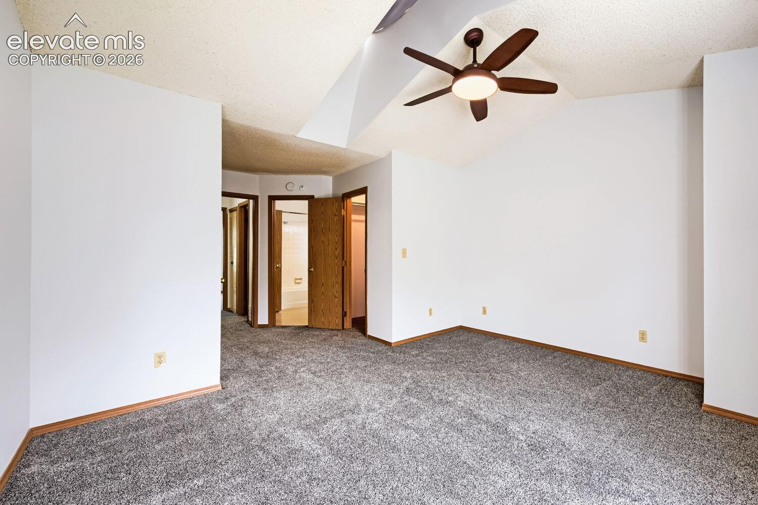 Vaulted ceiling featuring a ceiling fan with integrated lighting
