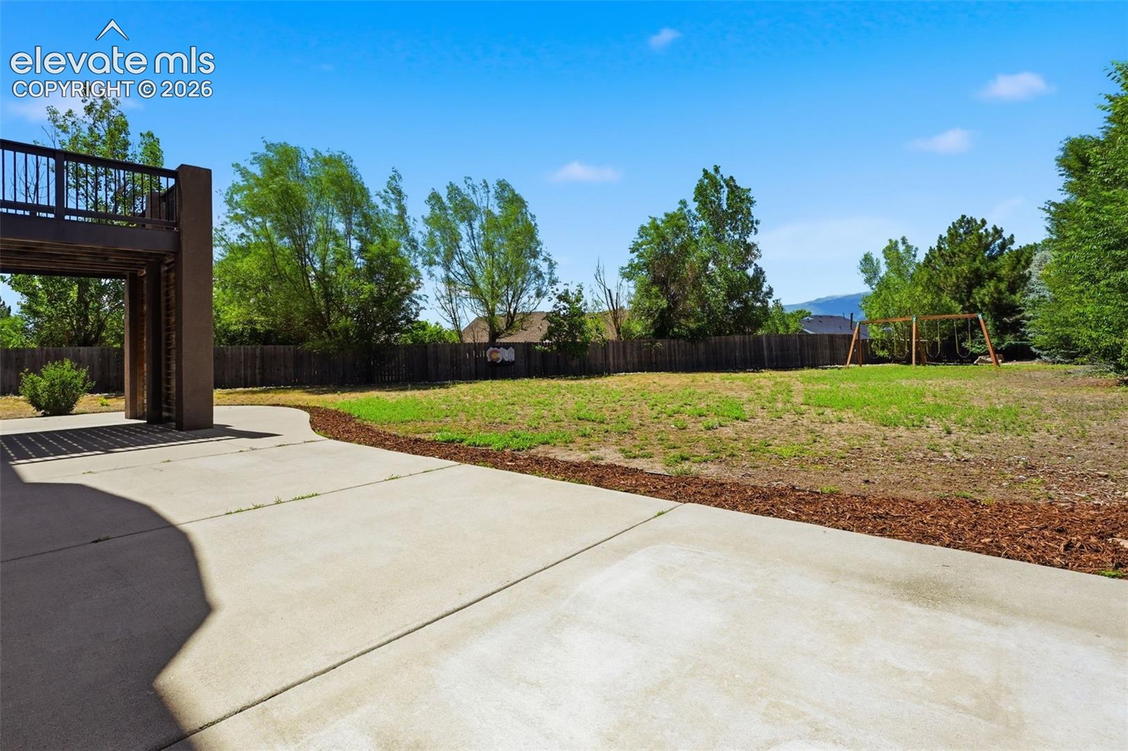 Park like back yard with views, large patio, hot tub wiring and included swing set!