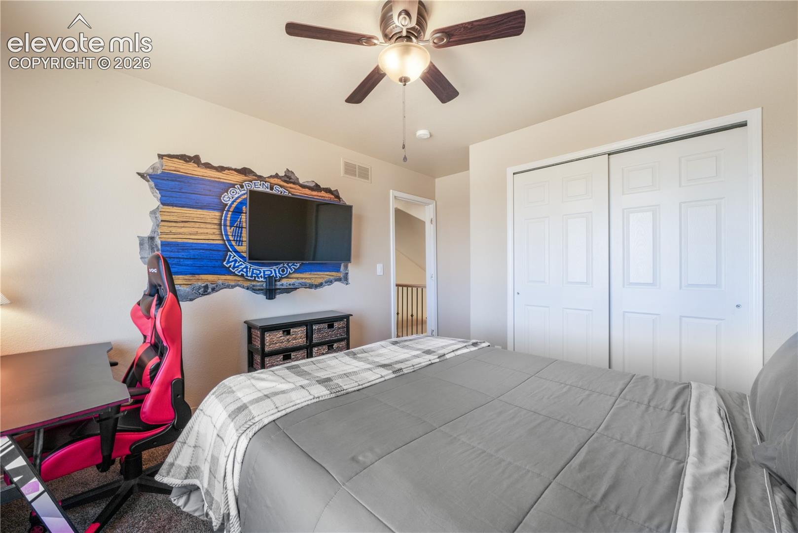 Upper Level Bedroom with Ceiling Fan and View.