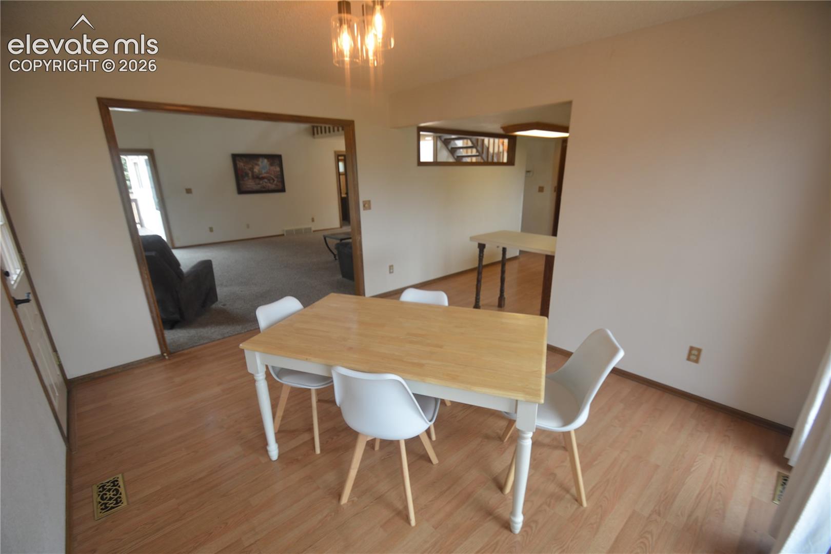 view from dining room to living room and kitchen