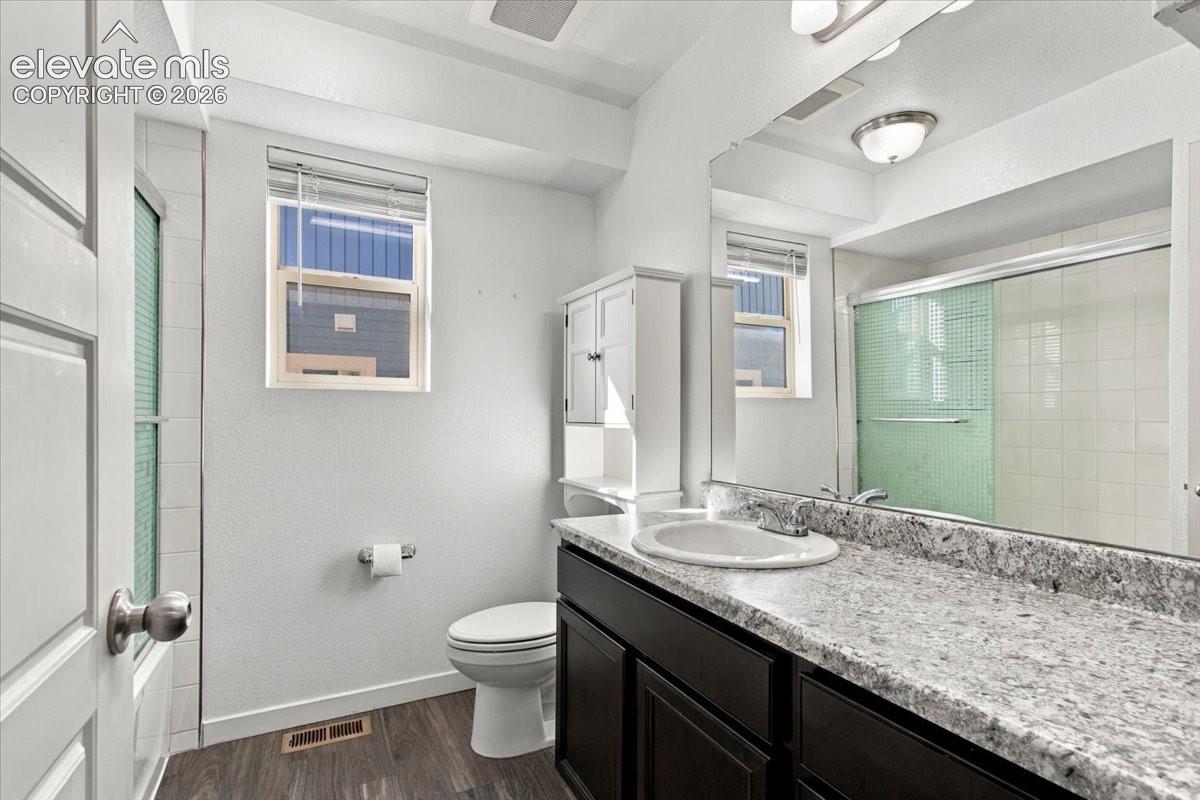Spacious vanity with a light-toned countertop, integrated sink, and dark wood-finish cabinetry