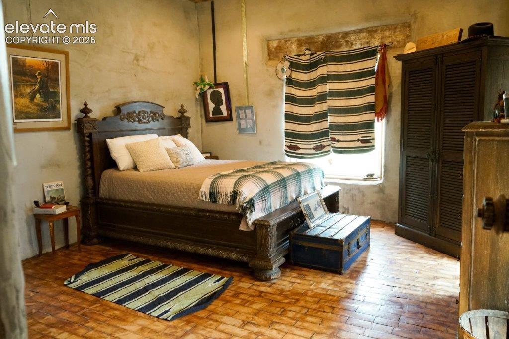 Textured wall finishes with a window featuring horizontal striped curtains
