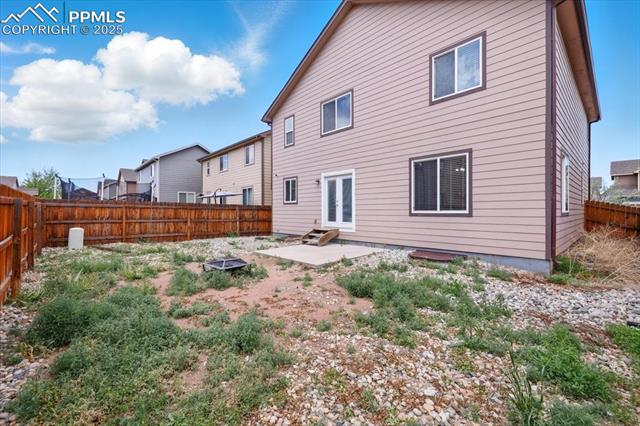 Back of property featuring a patio, a fenced backyard, and french doors