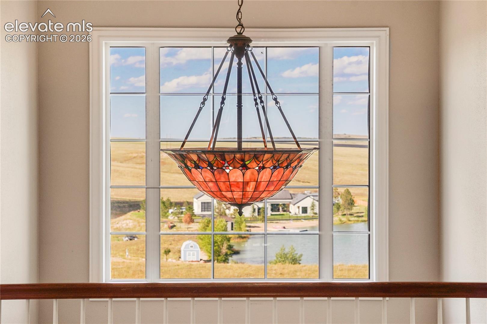 Upper landing has Lake Views beyond Tiffany-style Chandelier