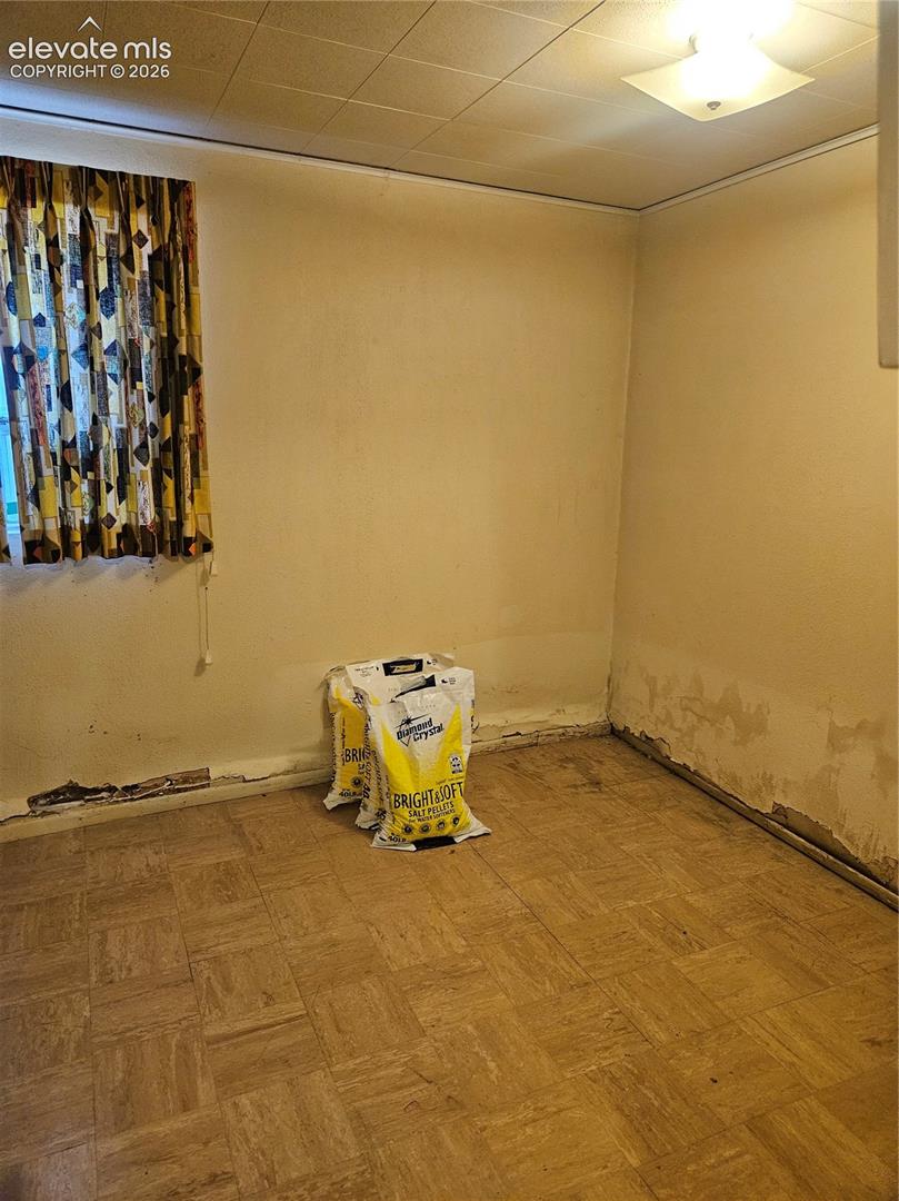 Extra room w/ closet in the basement. Notice damage to the bottom of the walls.