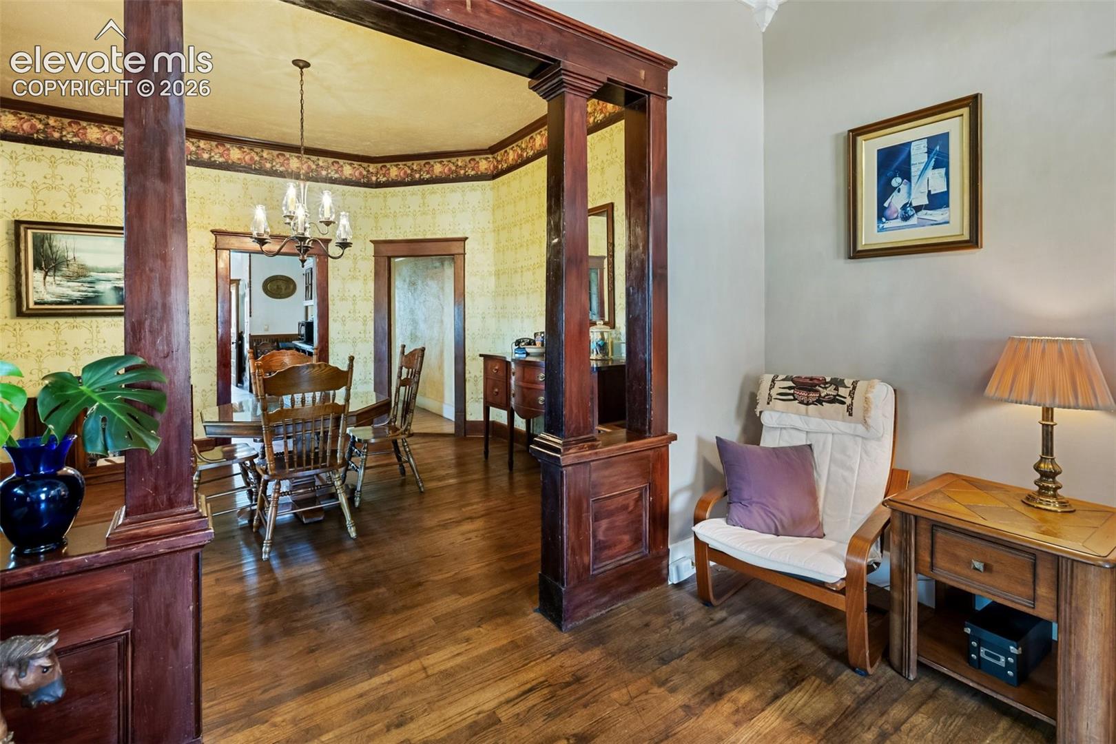 from the west end of the living room, looking over the table you can see the door into the kitchen