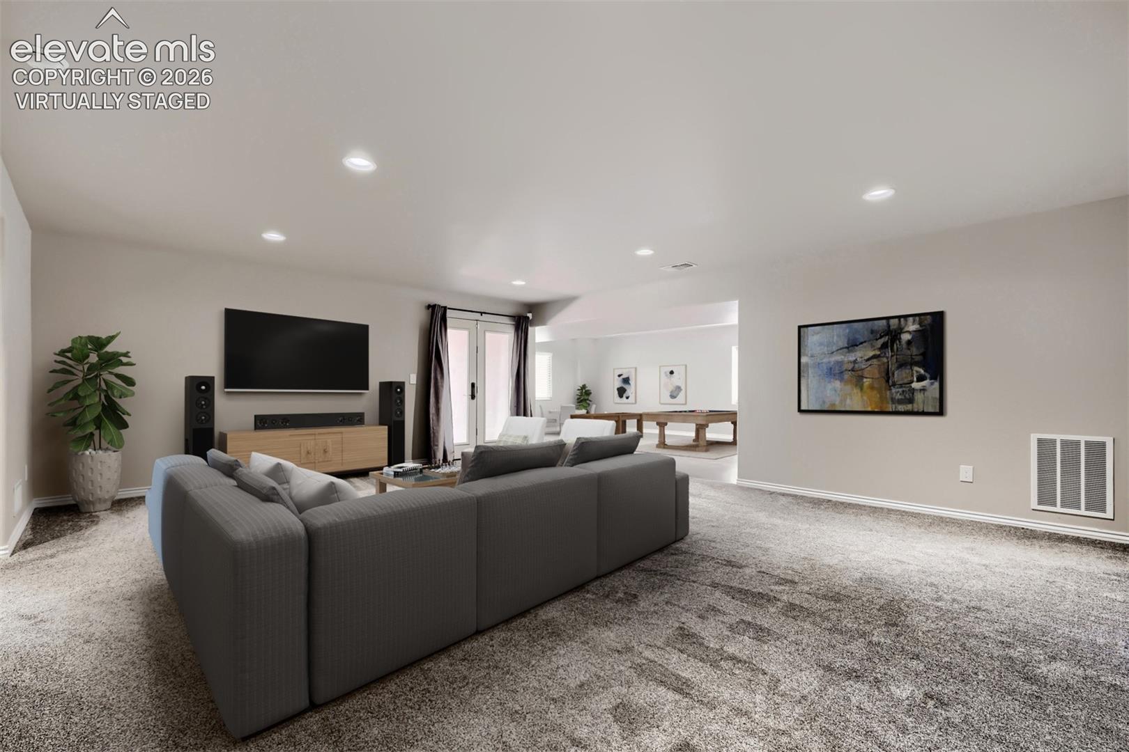Virtually staged basement family room with walkout, large rec room that can be game area, hobby area, playroom, or exercise room.
