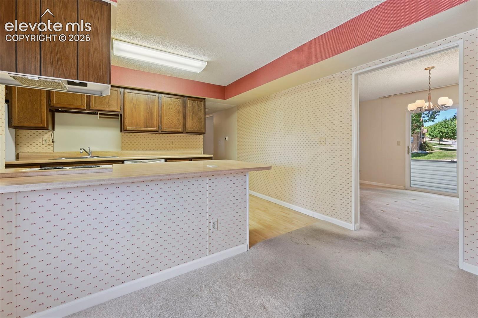 Plenty of cabinet space, breakfast bar, and a double basin sink