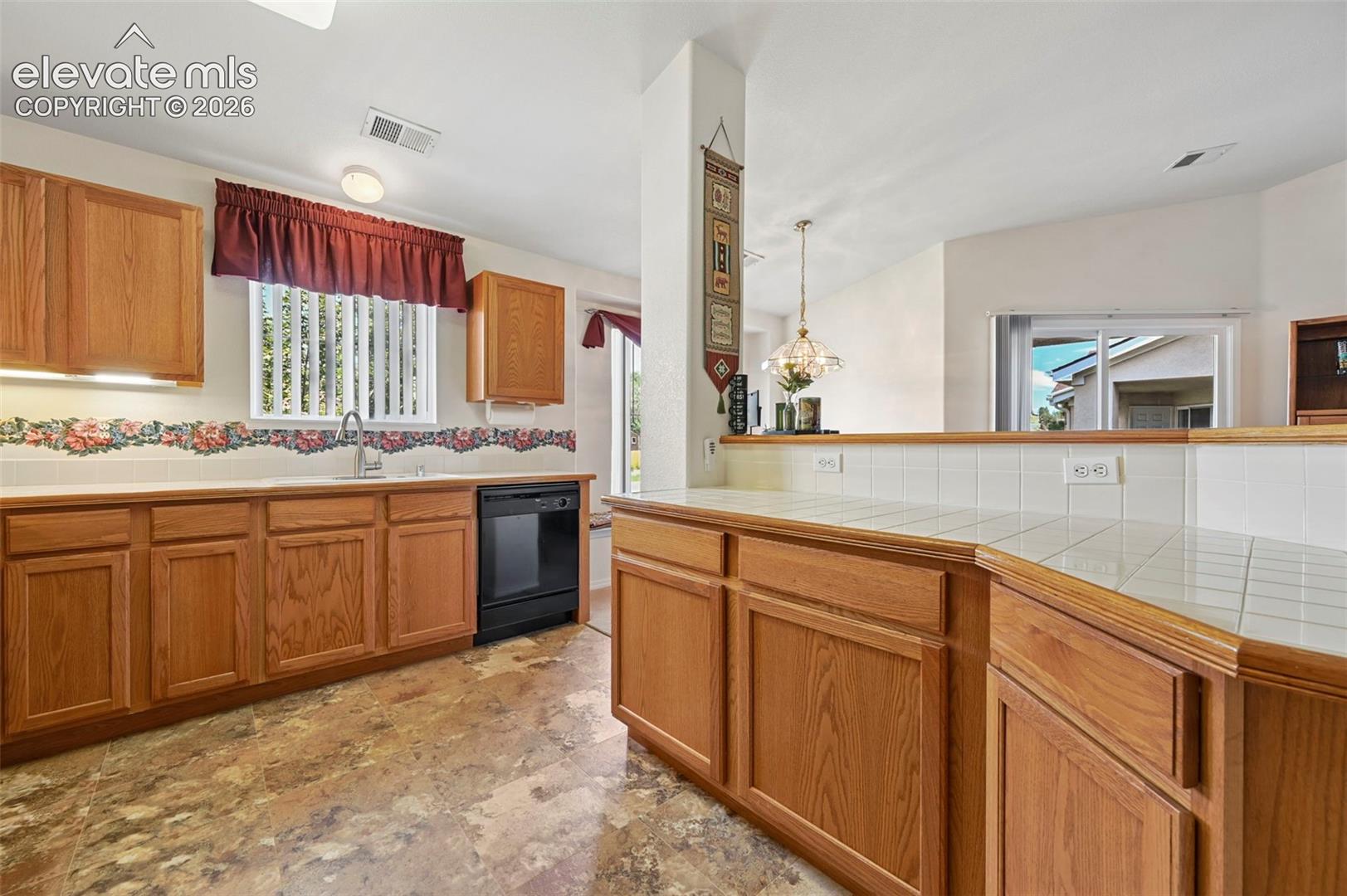 large open kitchen with breakfast bar overlooking diningand living rooms