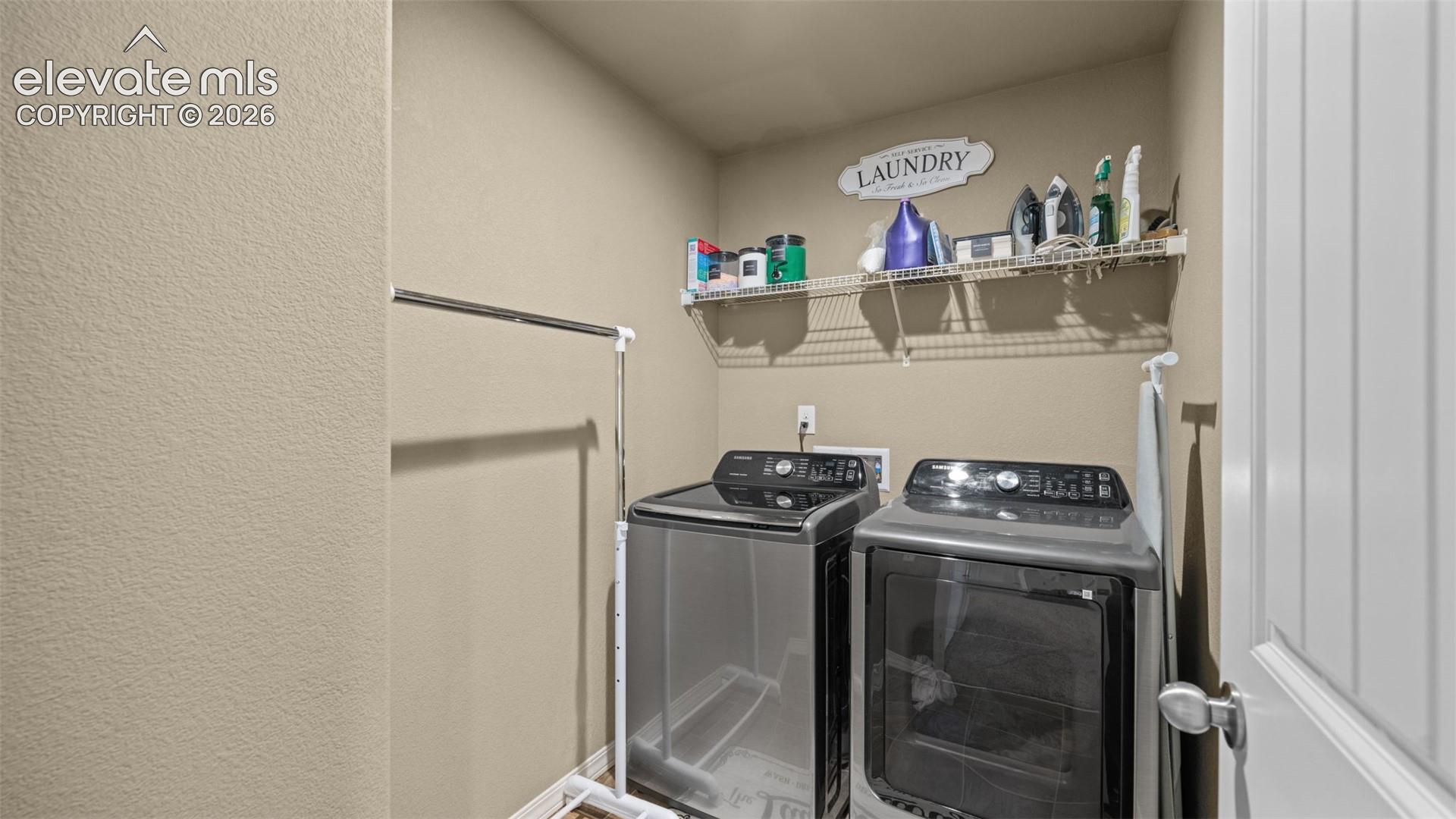 Dedicated laundry area featuring a wire shelving unit, providing ample storage
