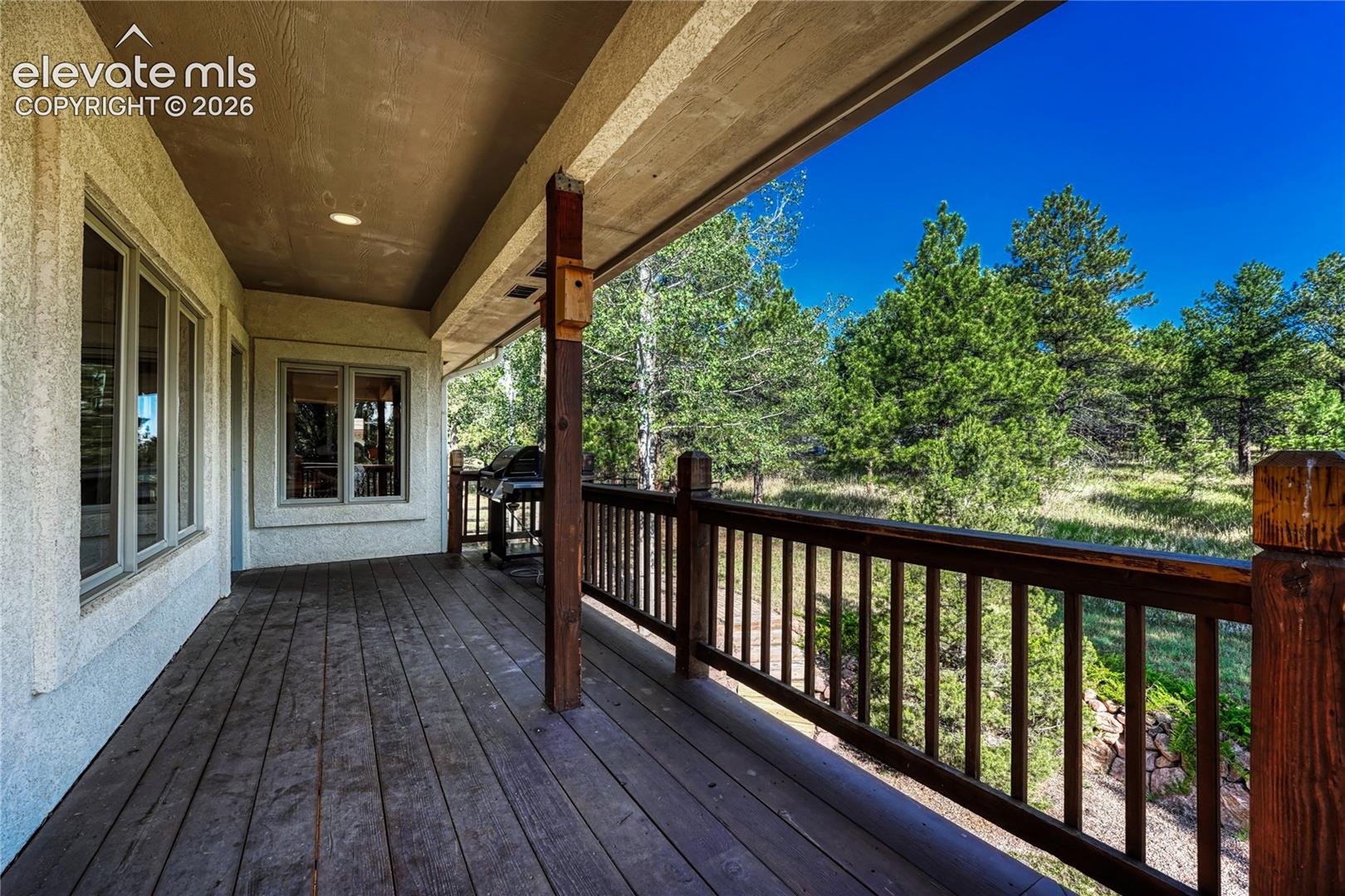 Covered wrap around wood deck.