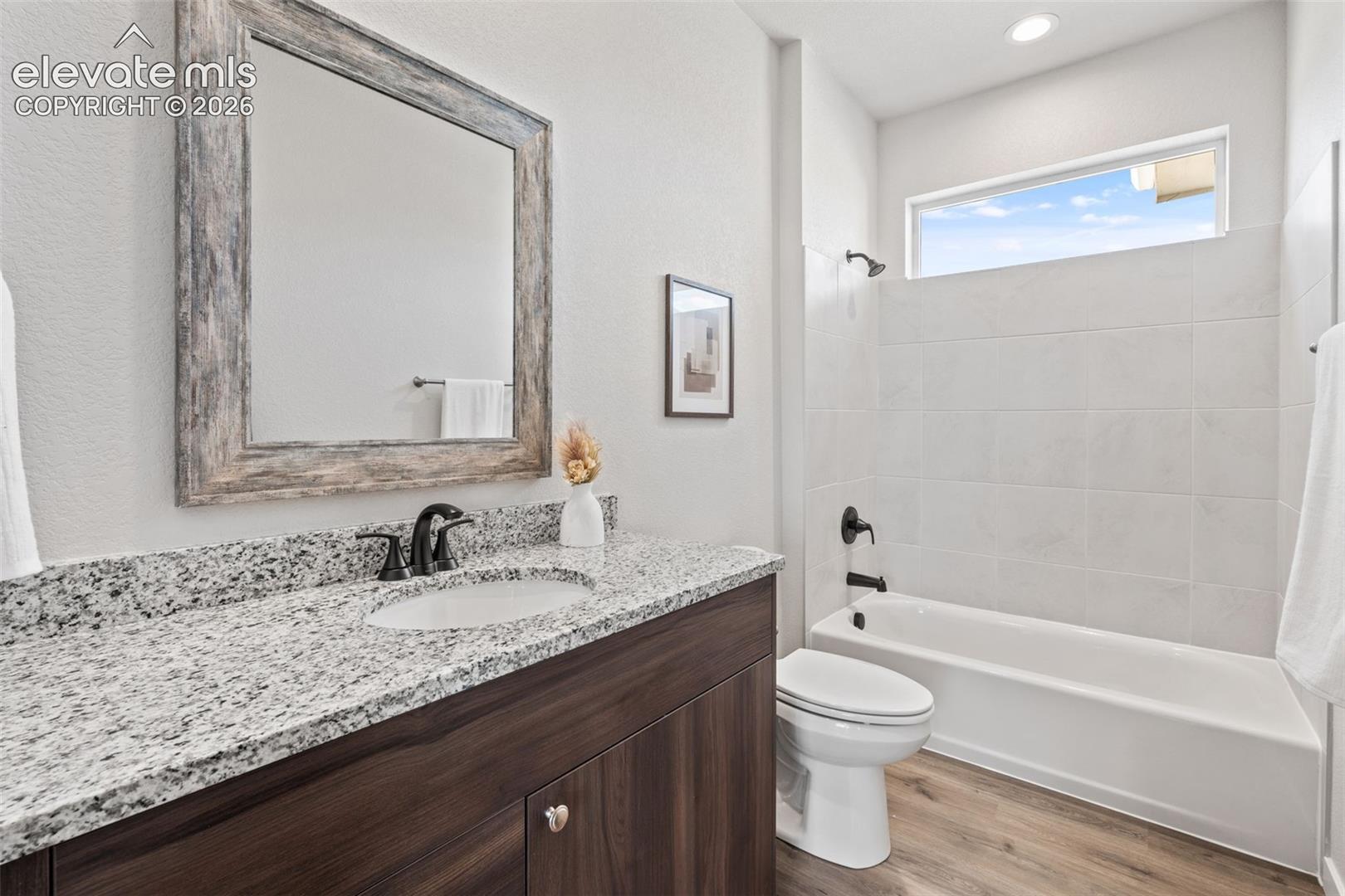 Vanity with a granite countertop and an undermount sink