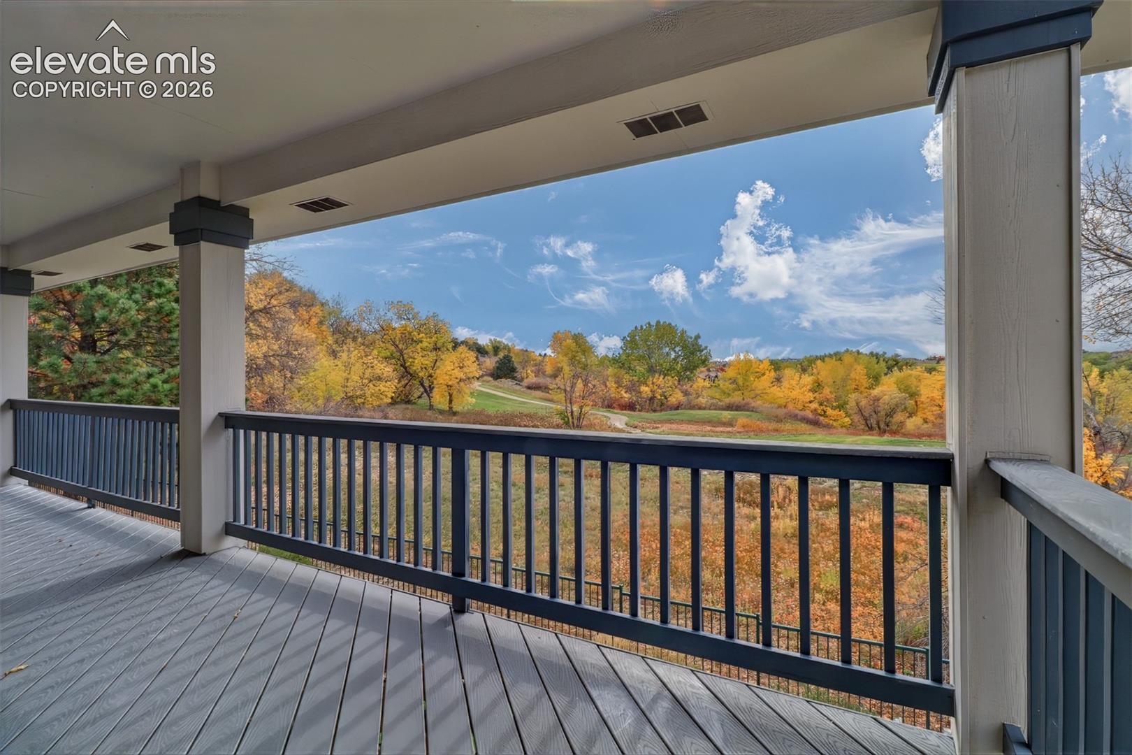 Covered back deck overlooking the yard and golf course