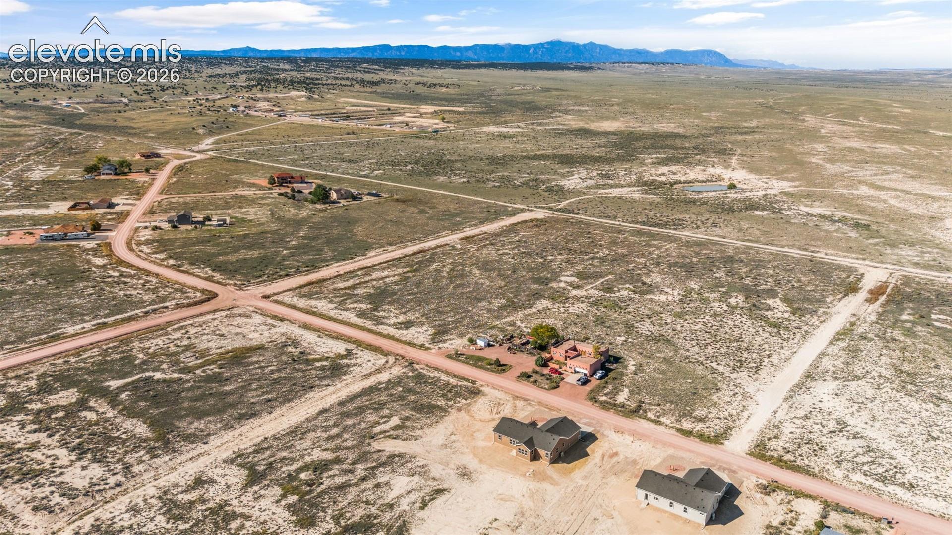 Expansive, undeveloped parcel featuring natural terrain and distant mountain ranges