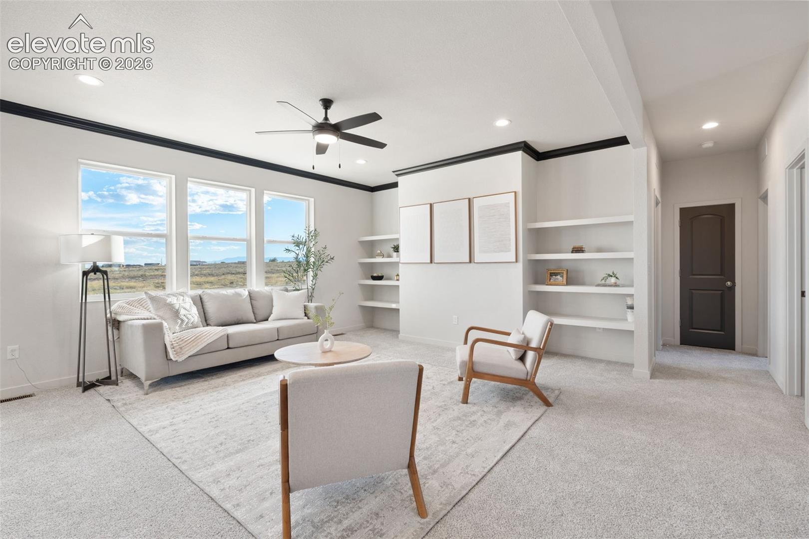 Spacious room featuring multiple windows, recessed lighting, built-in shelving, a ceiling fan, and light-colored carpeting
