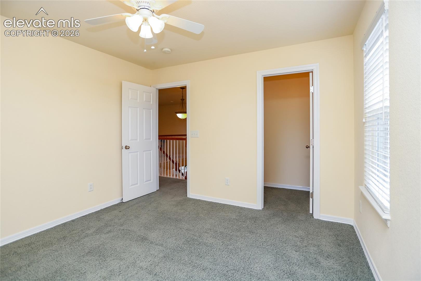 Bedroom 3 on the upper level has a walk-in closet and mountain and Pikes Peak views from the side window!