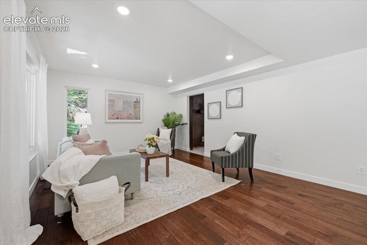 Recessed lighting, dark wood flooring, and white walls. Bright Modern Feel