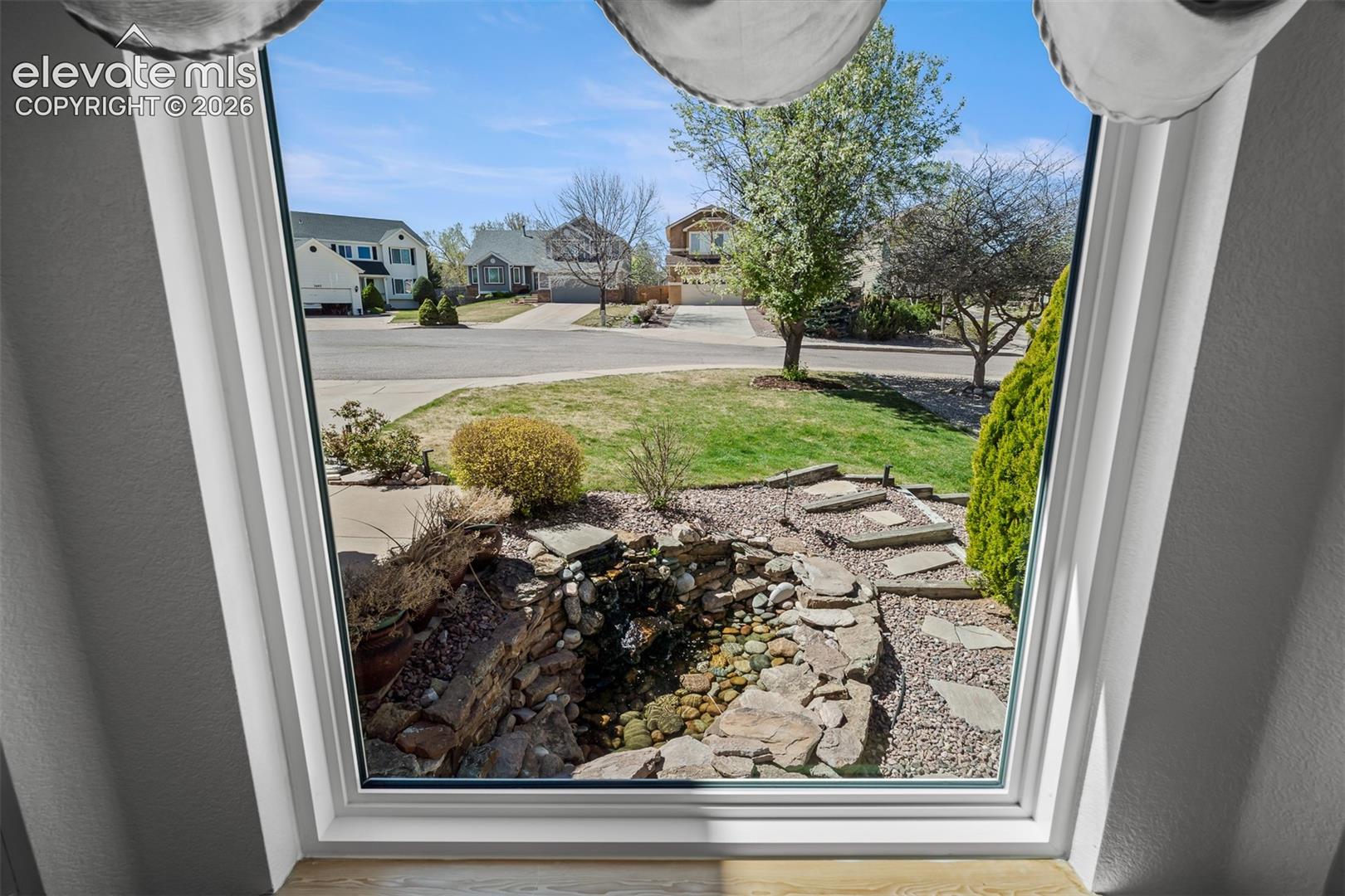Great view of front lawn water feature from livingroom bay window.