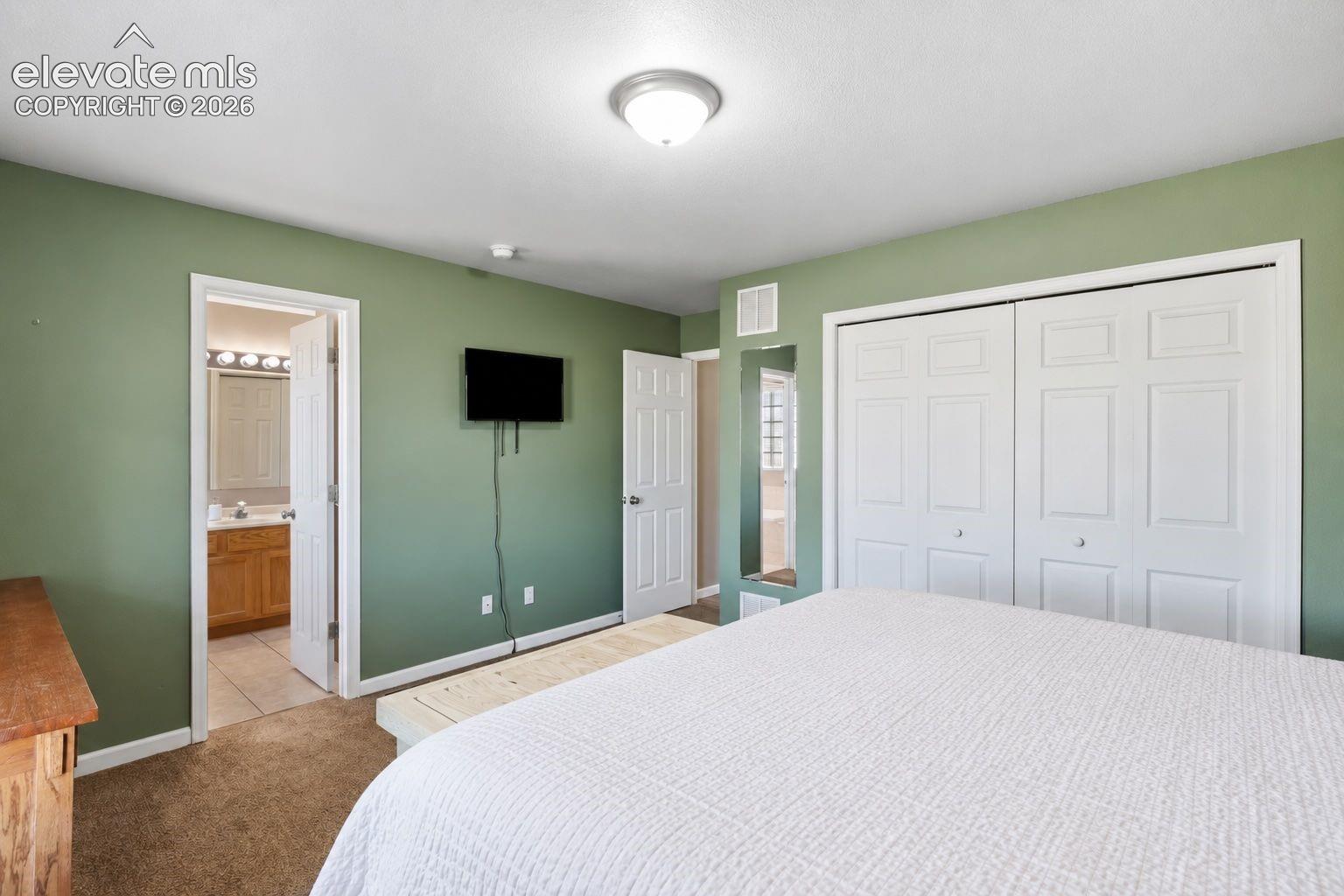 Primary bedroom with full ensuite bathroom.