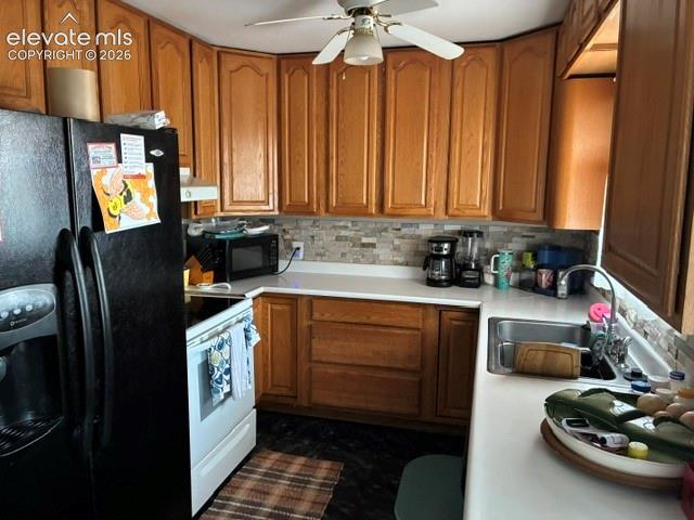 Warm wood cabinetry with raised-panel doors and ample storage, complemented by white countertops and a tile backsplash