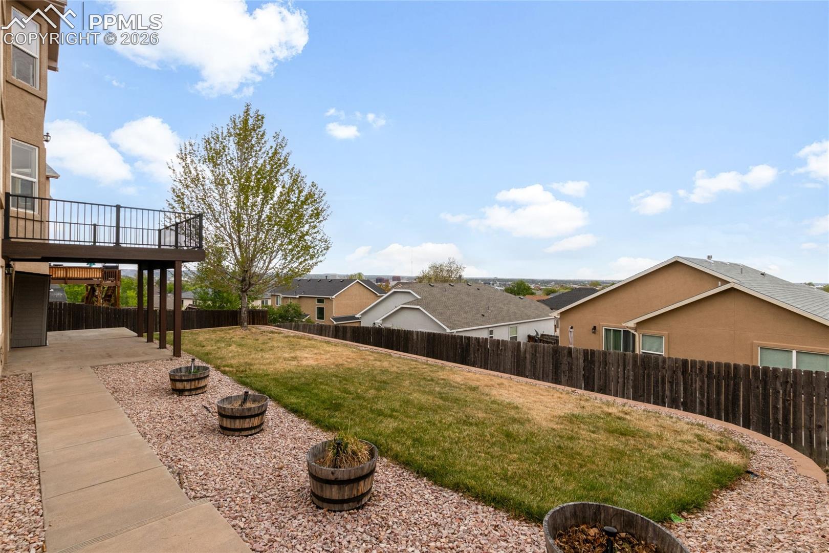 Stucco exterior featuring stacked stone accents, a three-car garage, and a concrete driveway