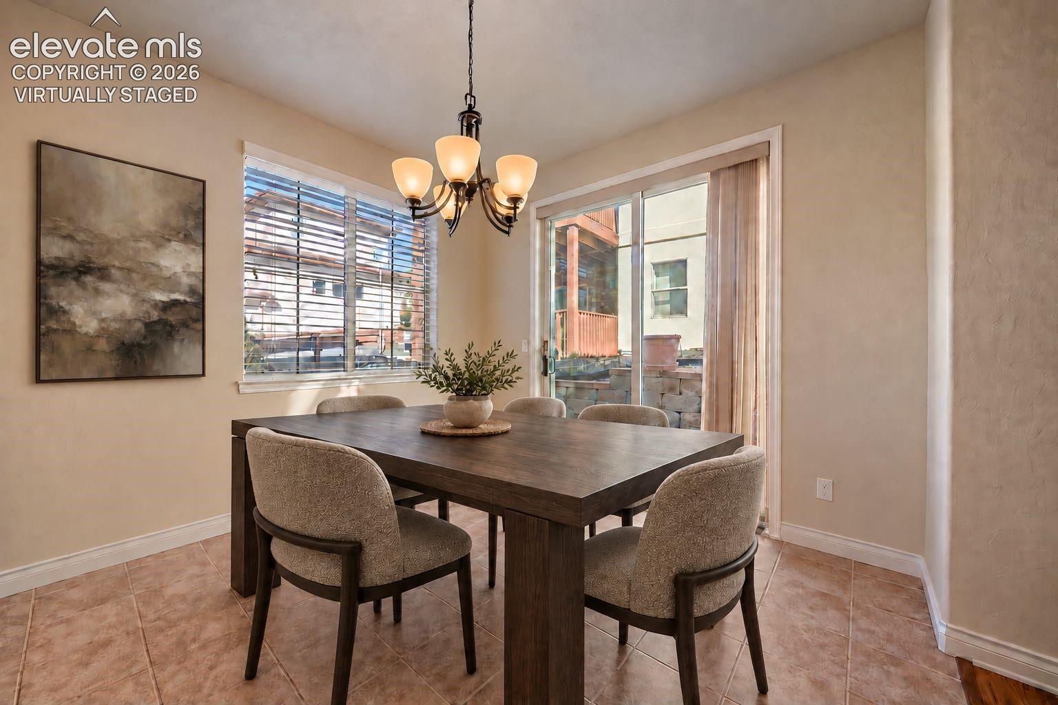 Virtually Staged. Dining area featuring tile flooring, a multi-arm chandelier, large windows, and a sliding glass door