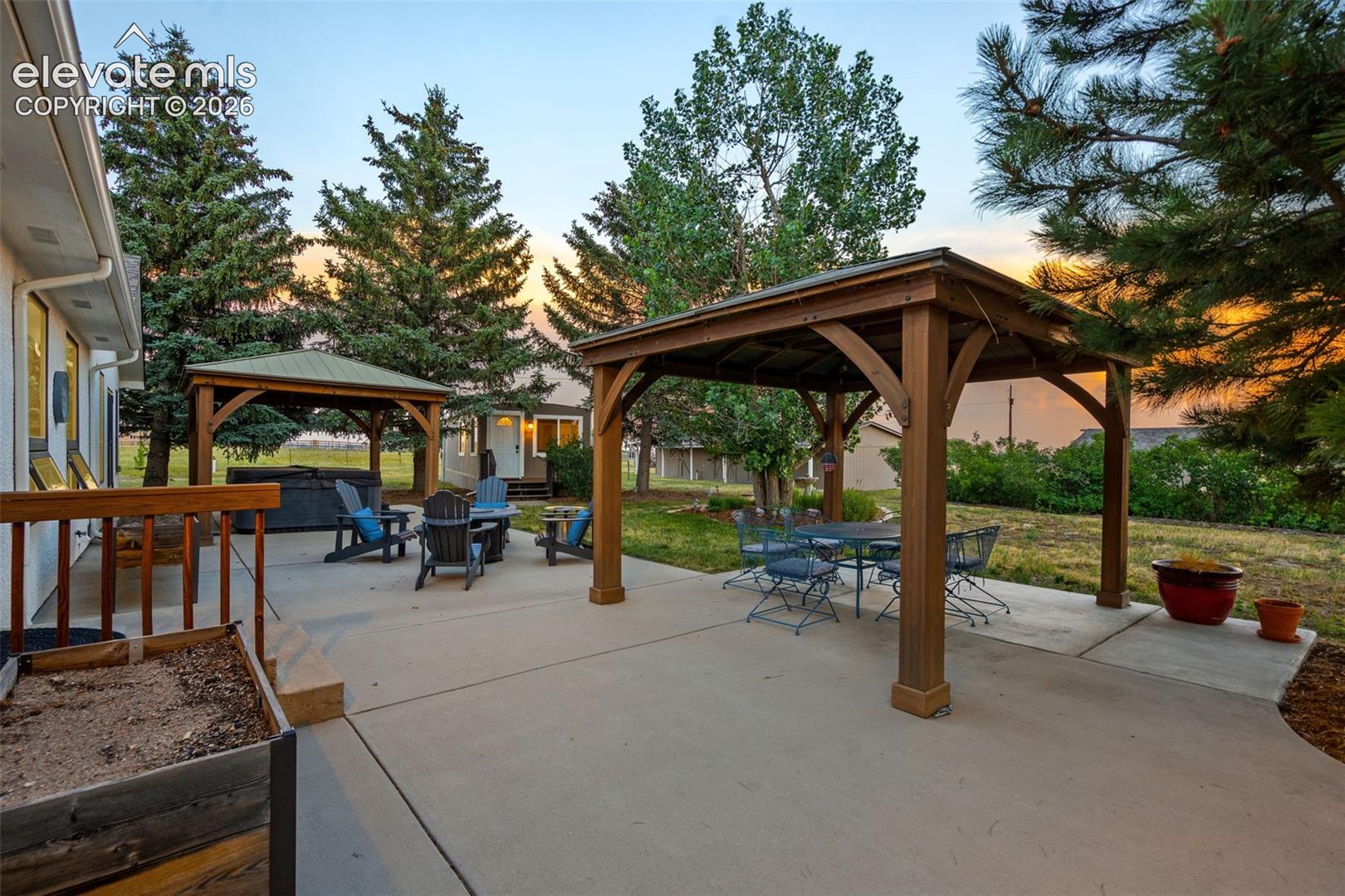 Rear patio with 2 gazebos and hot tub 