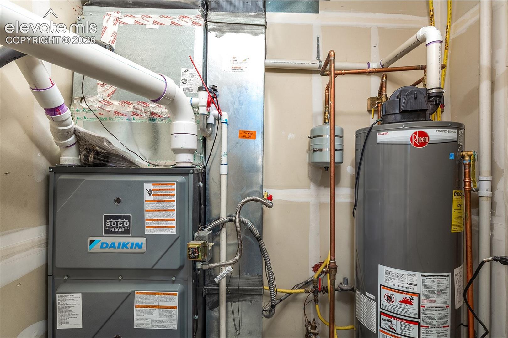 Hot water heater, furnace, and A/C located in utility room off patio