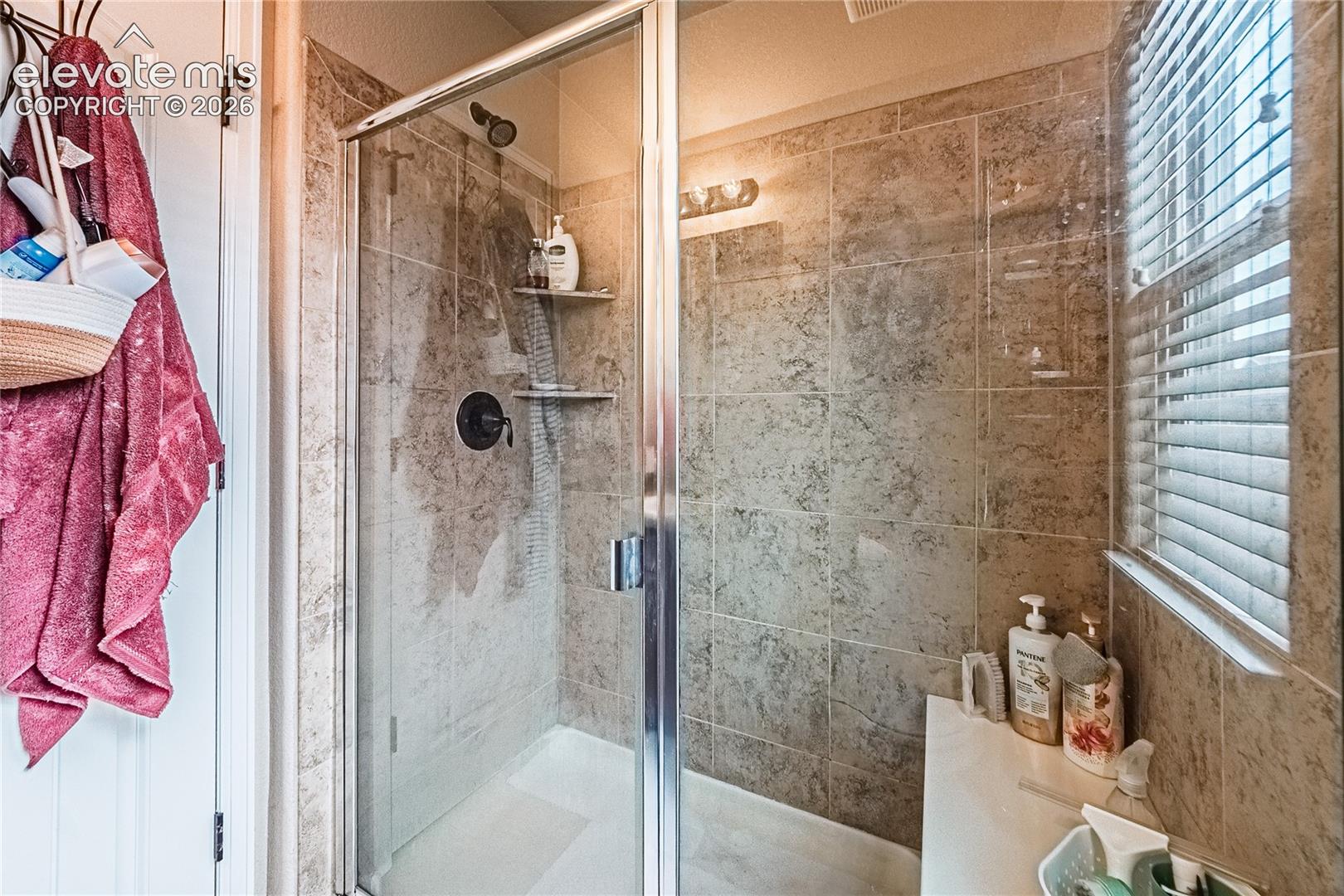 Full bathroom featuring a shower stall