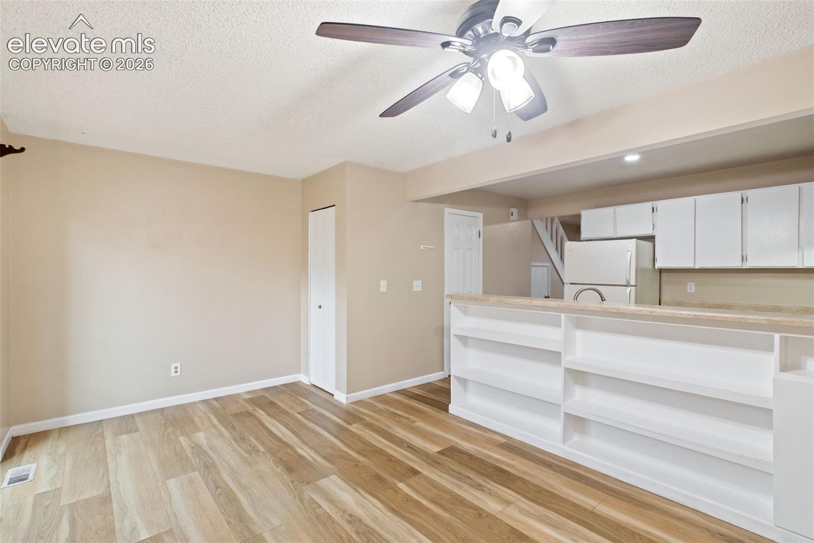 The Dining Room features built-in shelving and sliding glass doors which provide natural lighting as well as access to the home's exterior private deck!