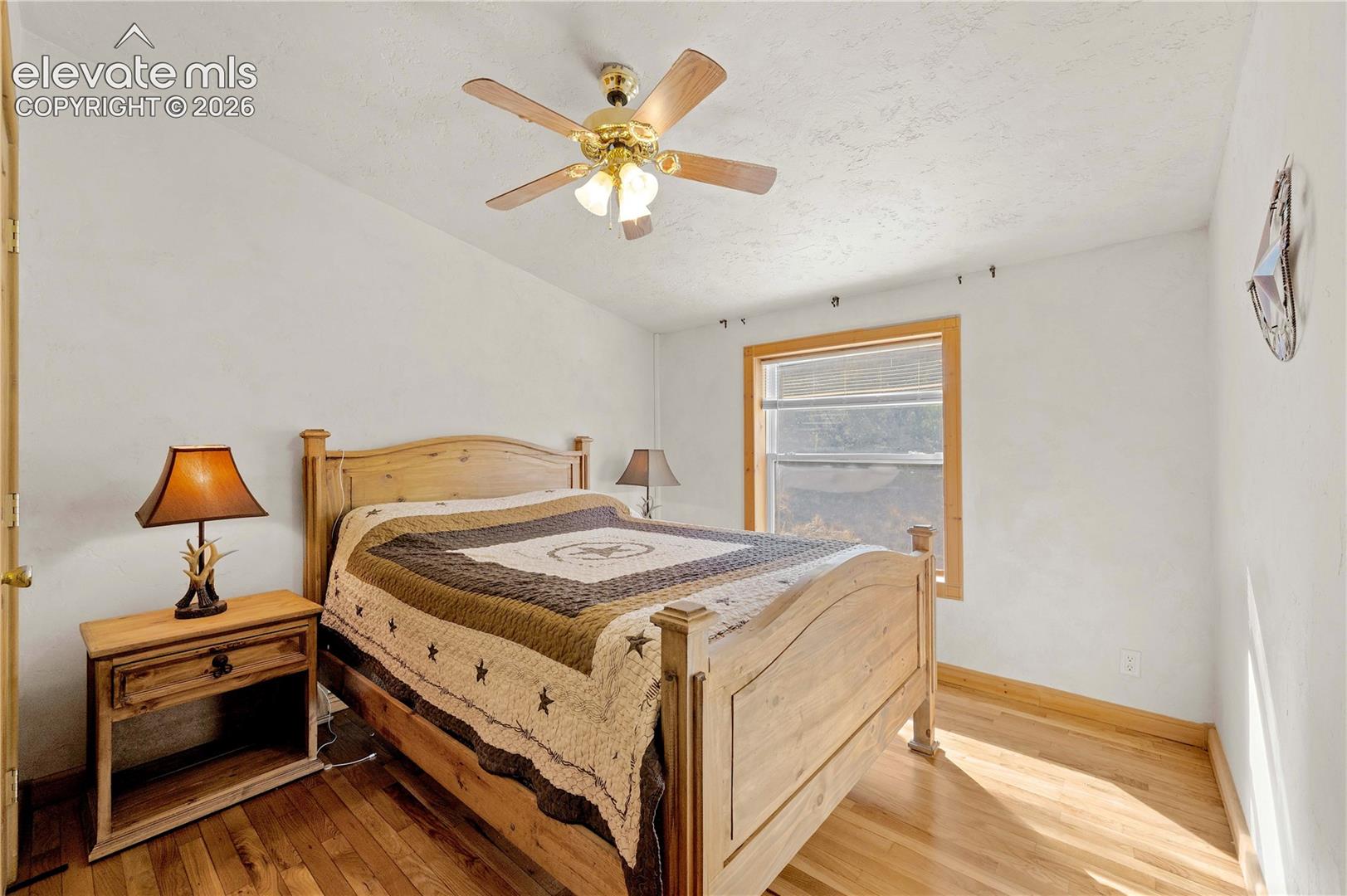 Bedroom with light wood-type flooring and ceiling fan